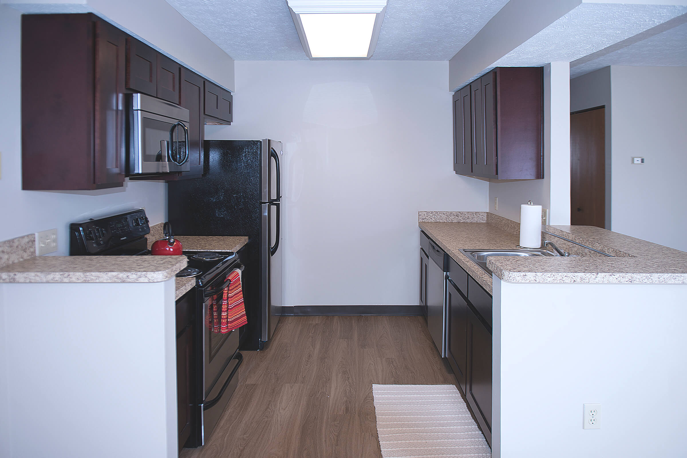 a kitchen with a stove sink and refrigerator