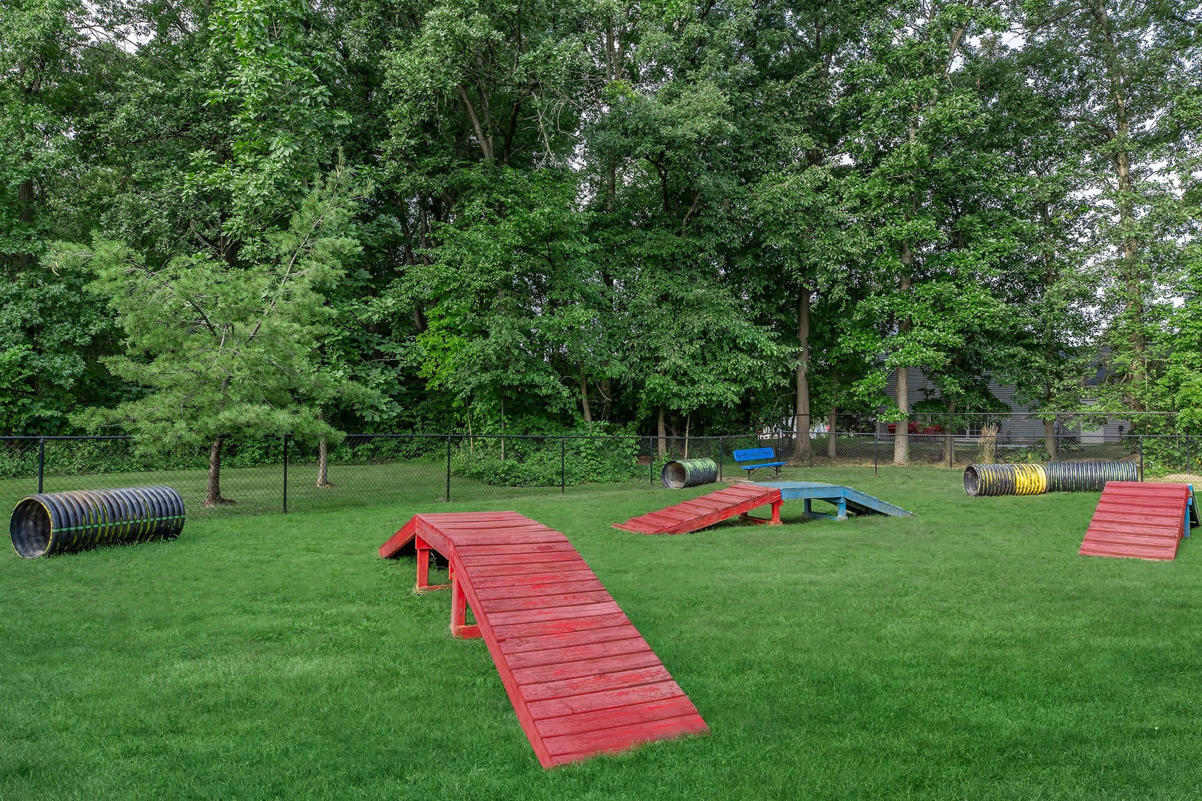 a group of lawn chairs sitting on top of a lush green field