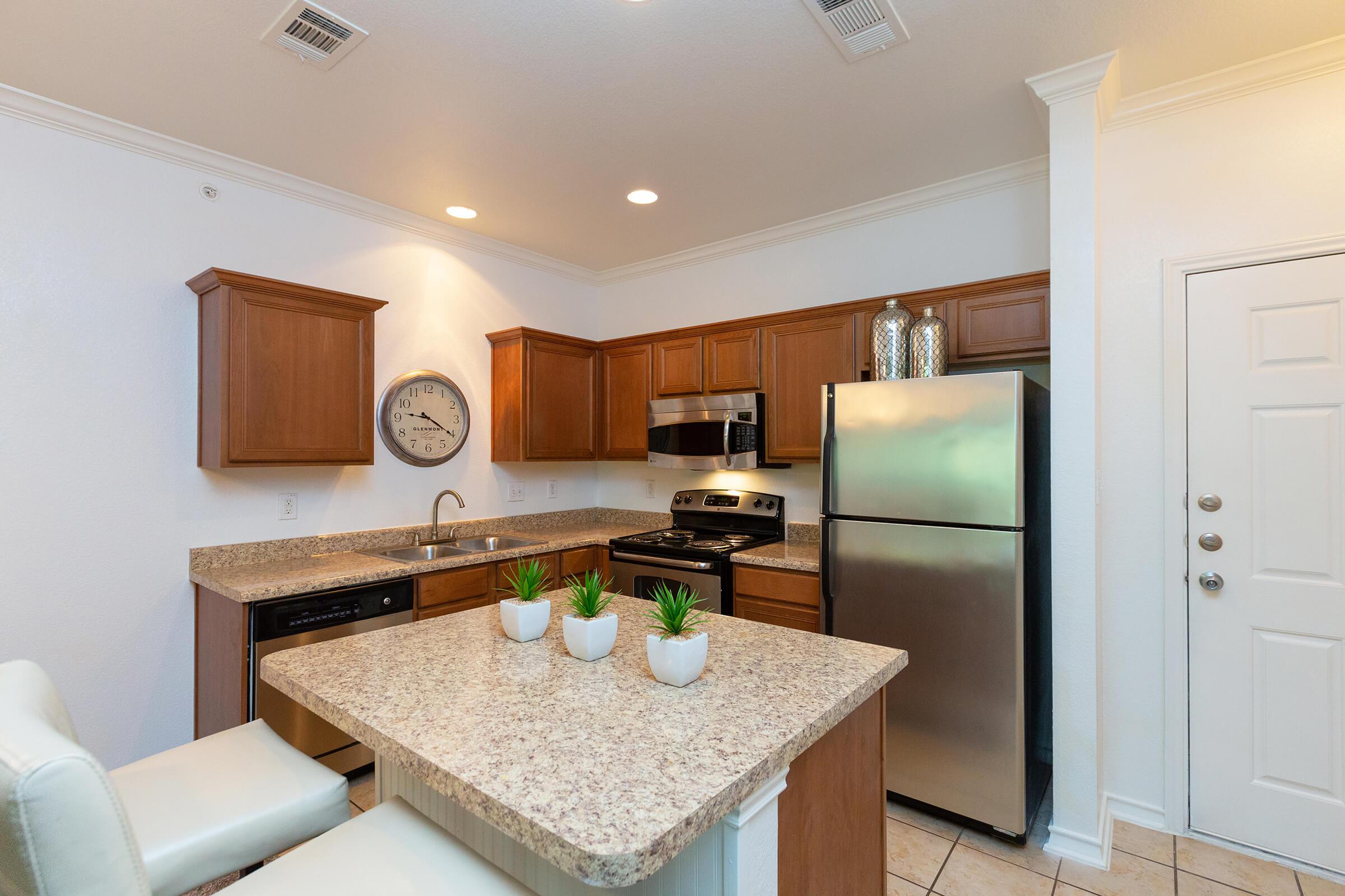 a kitchen with a sink and a mirror