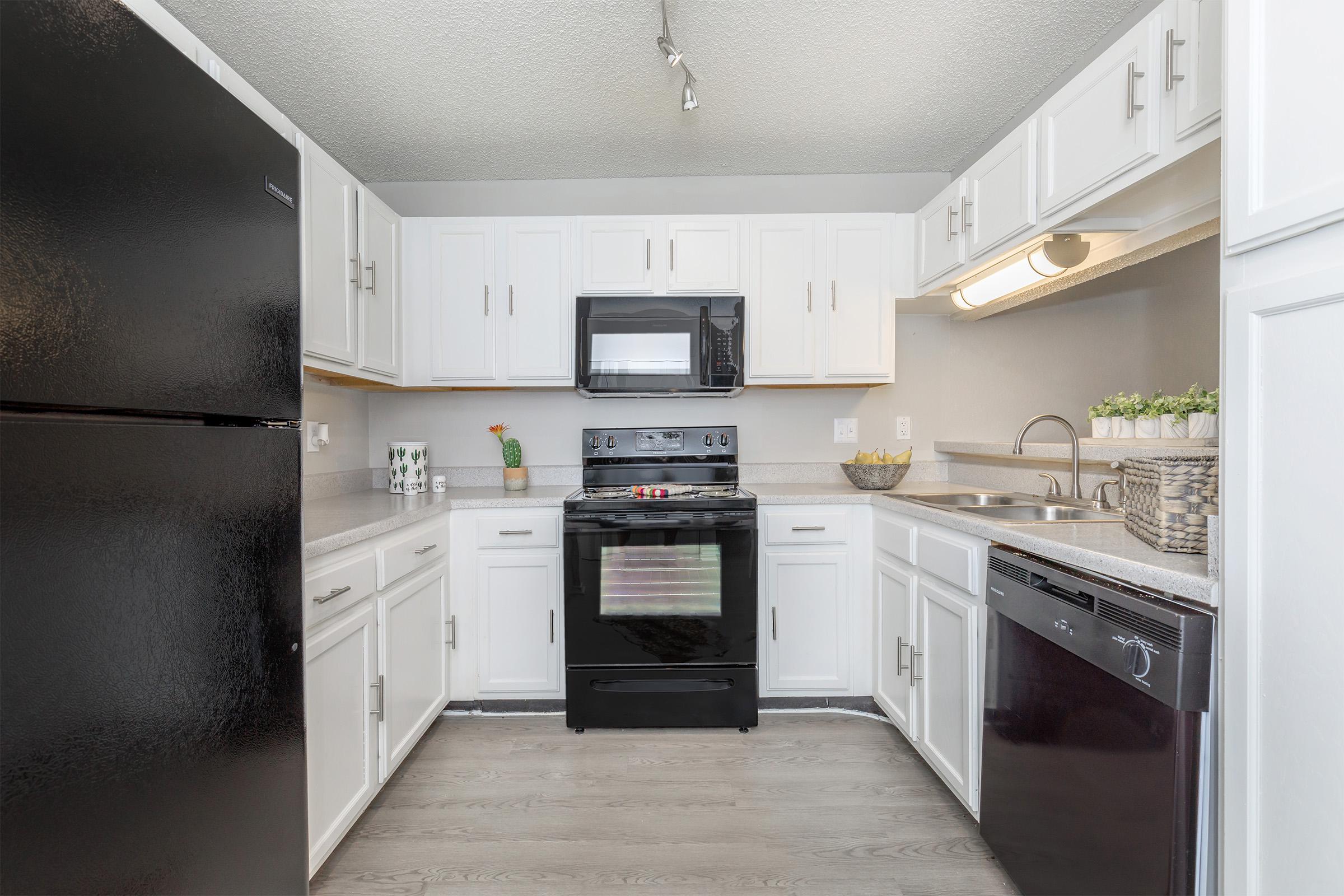 a kitchen with a stove and a refrigerator