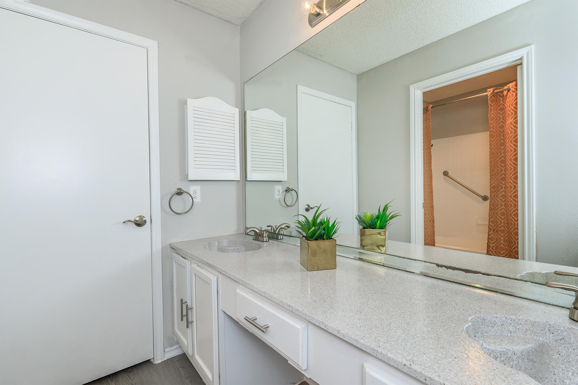 a kitchen with a sink and a mirror