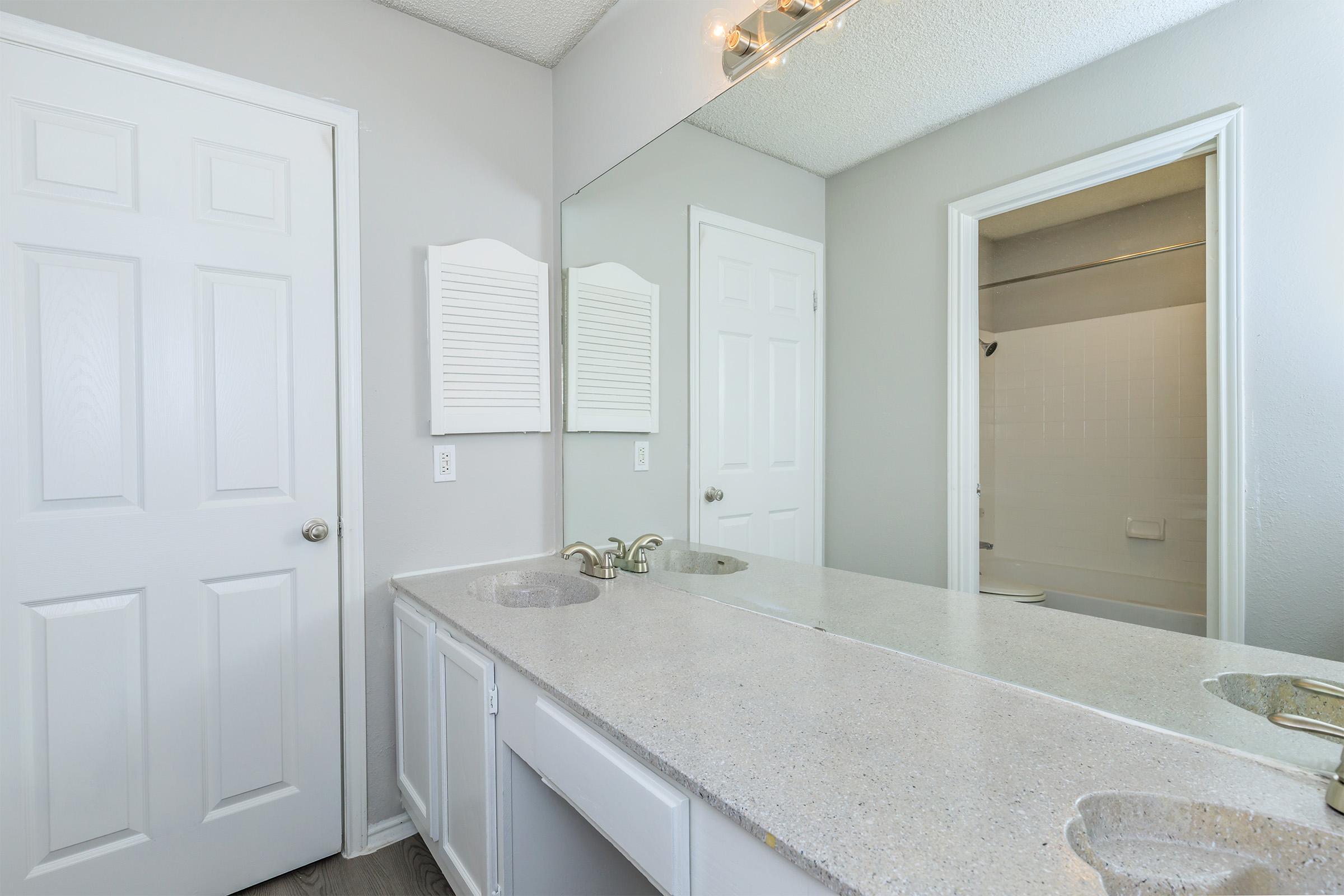 a kitchen with a sink and a mirror