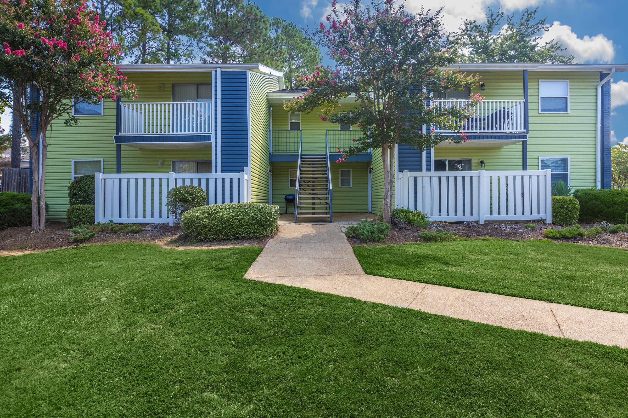 a house with a lawn in front of a building