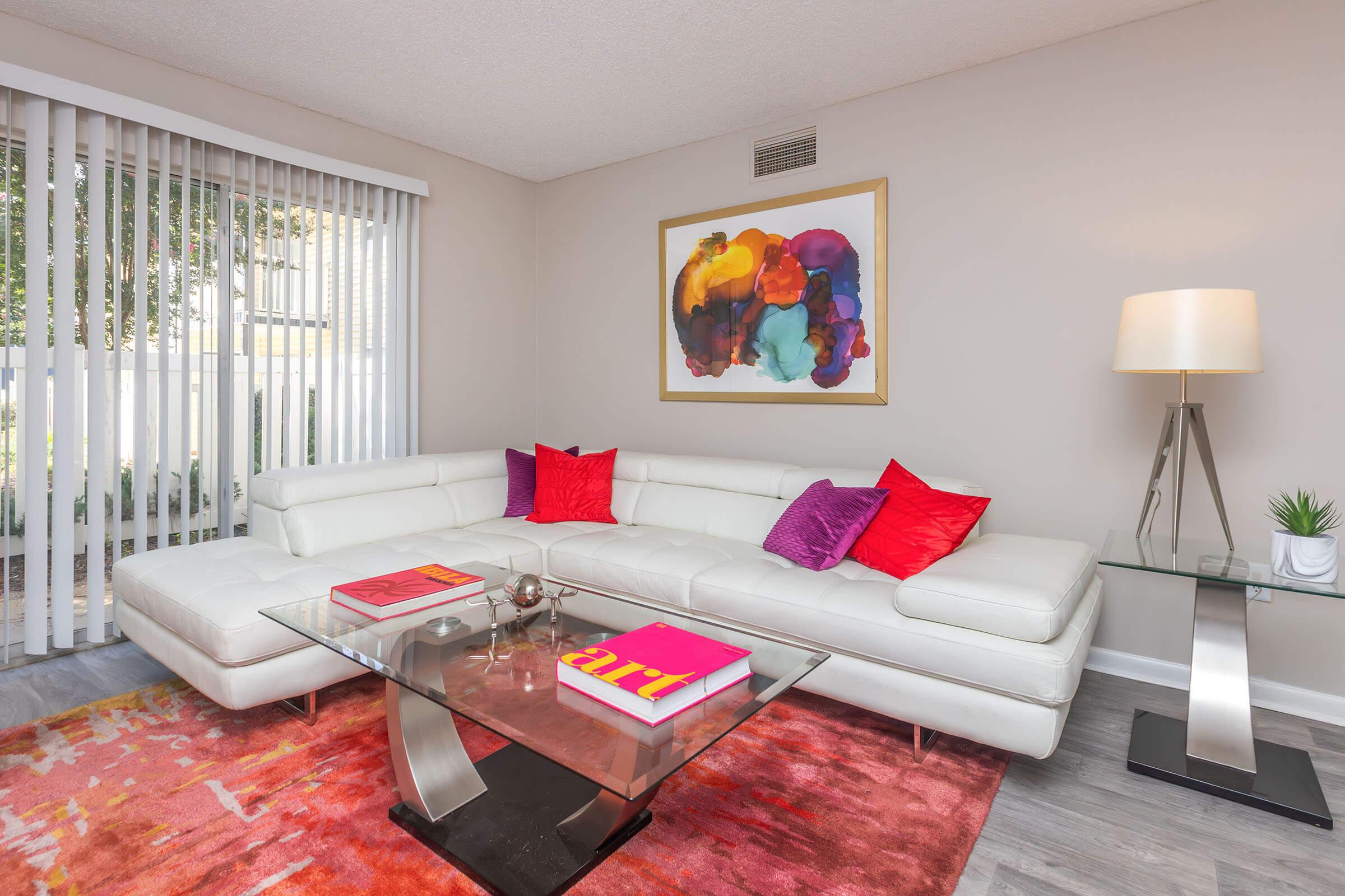 a living room filled with furniture and a flat screen tv