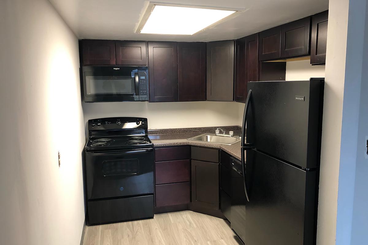 a kitchen with a stove and a refrigerator