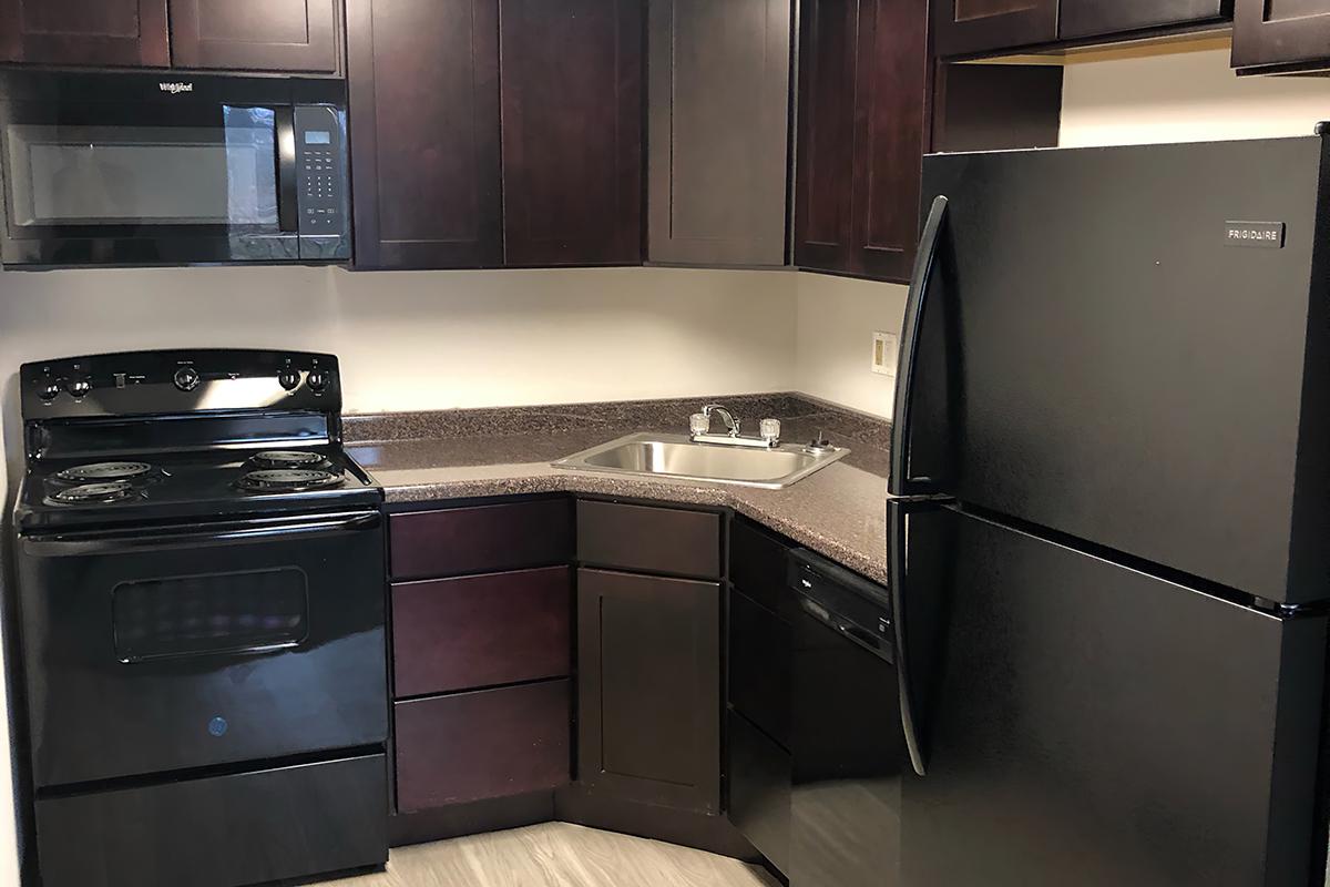 a kitchen with a stove microwave and refrigerator