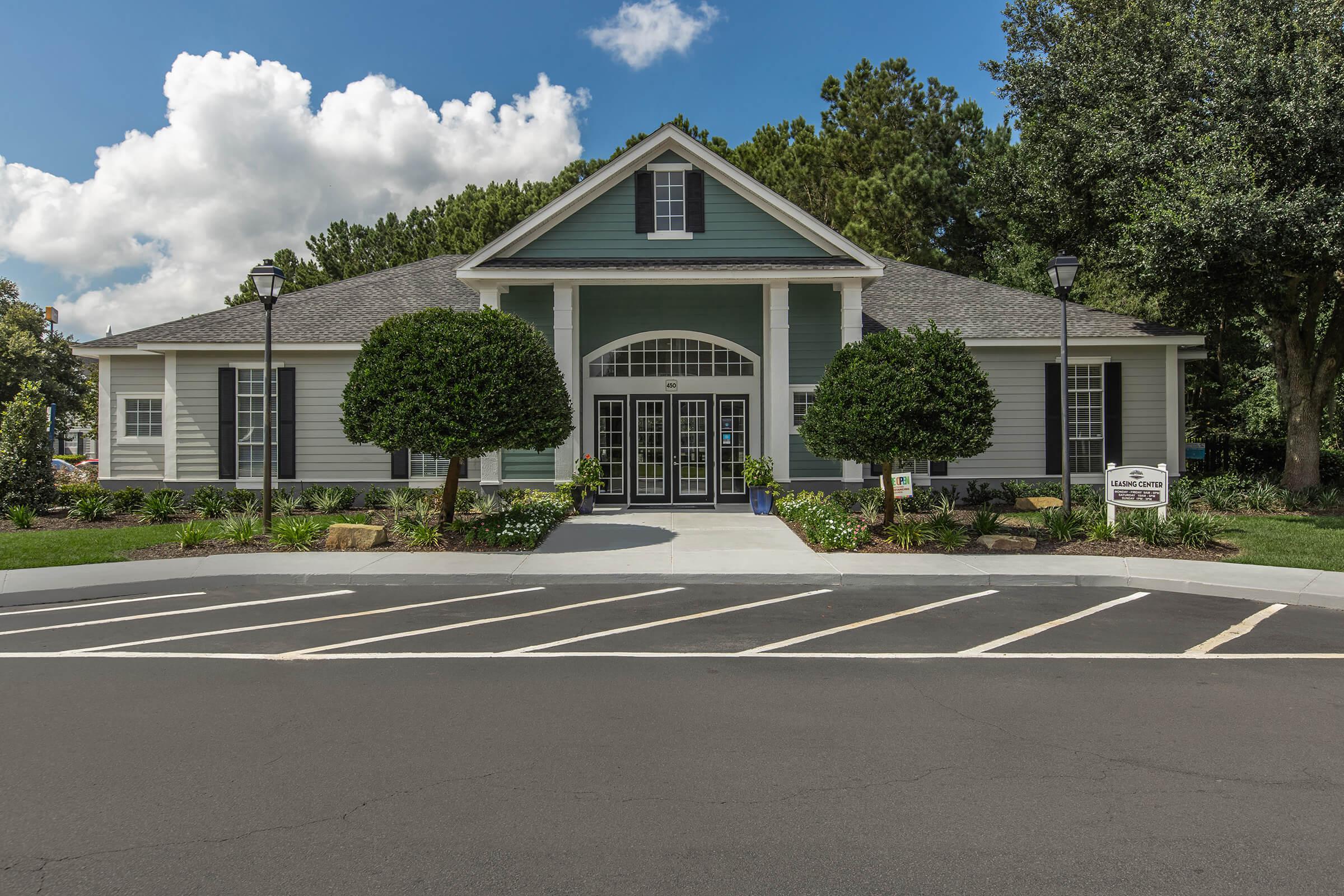 an empty parking lot in front of a house