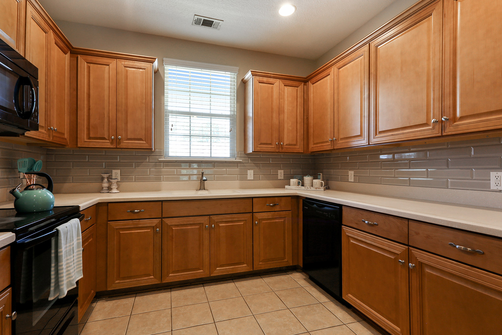 a kitchen with stainless steel appliances and wooden cabinets