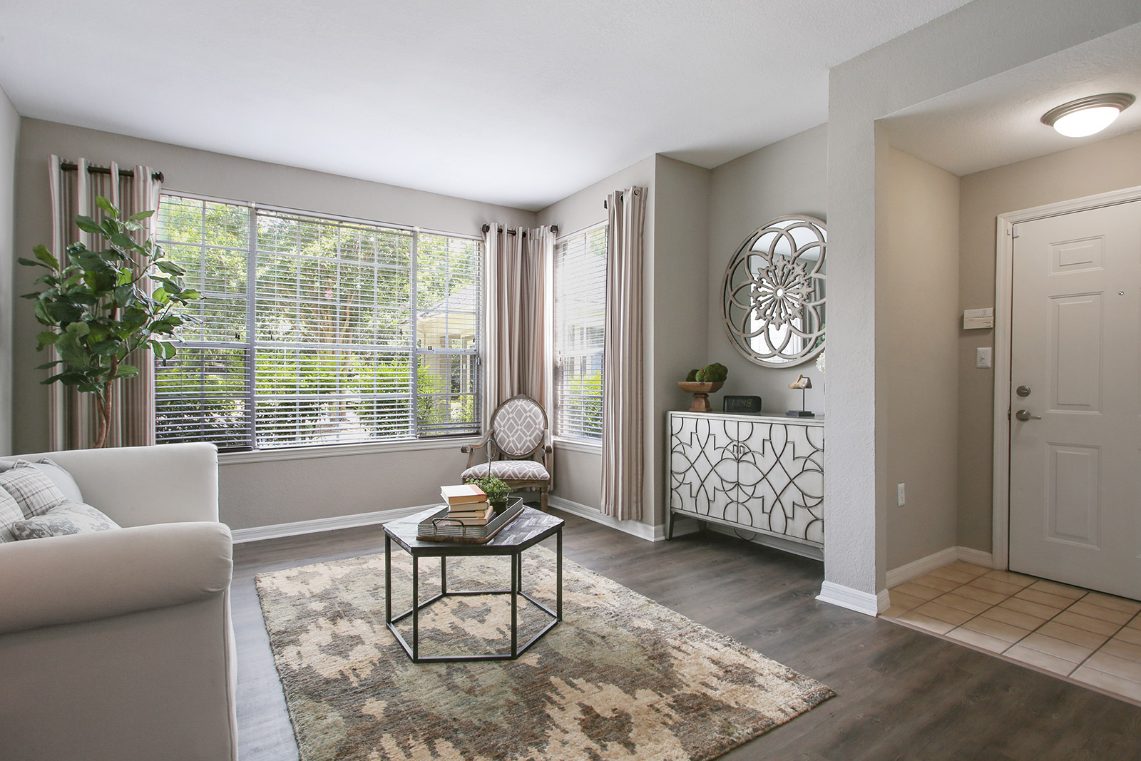 a living room filled with furniture and a large window