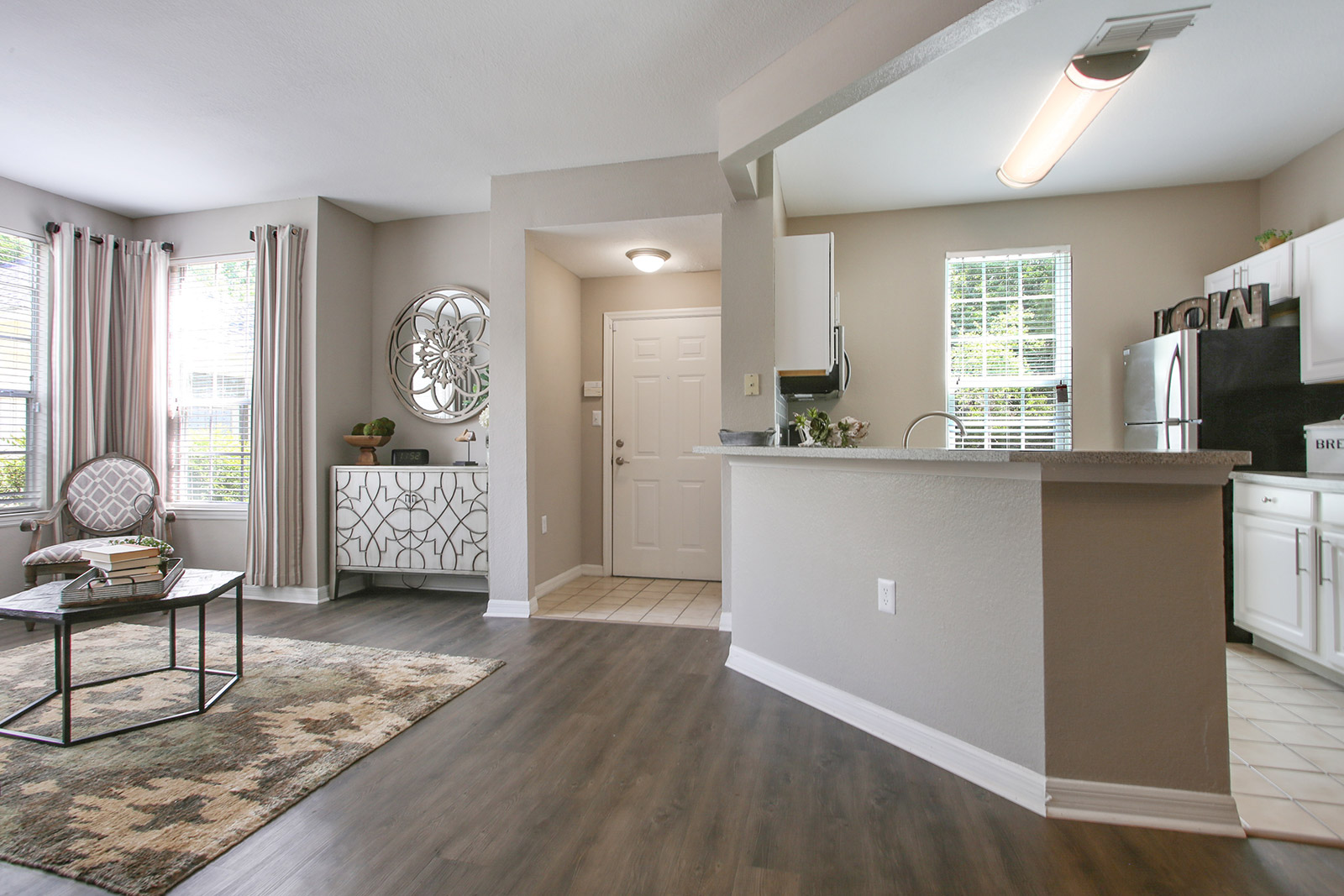 a living room filled with furniture and a large window