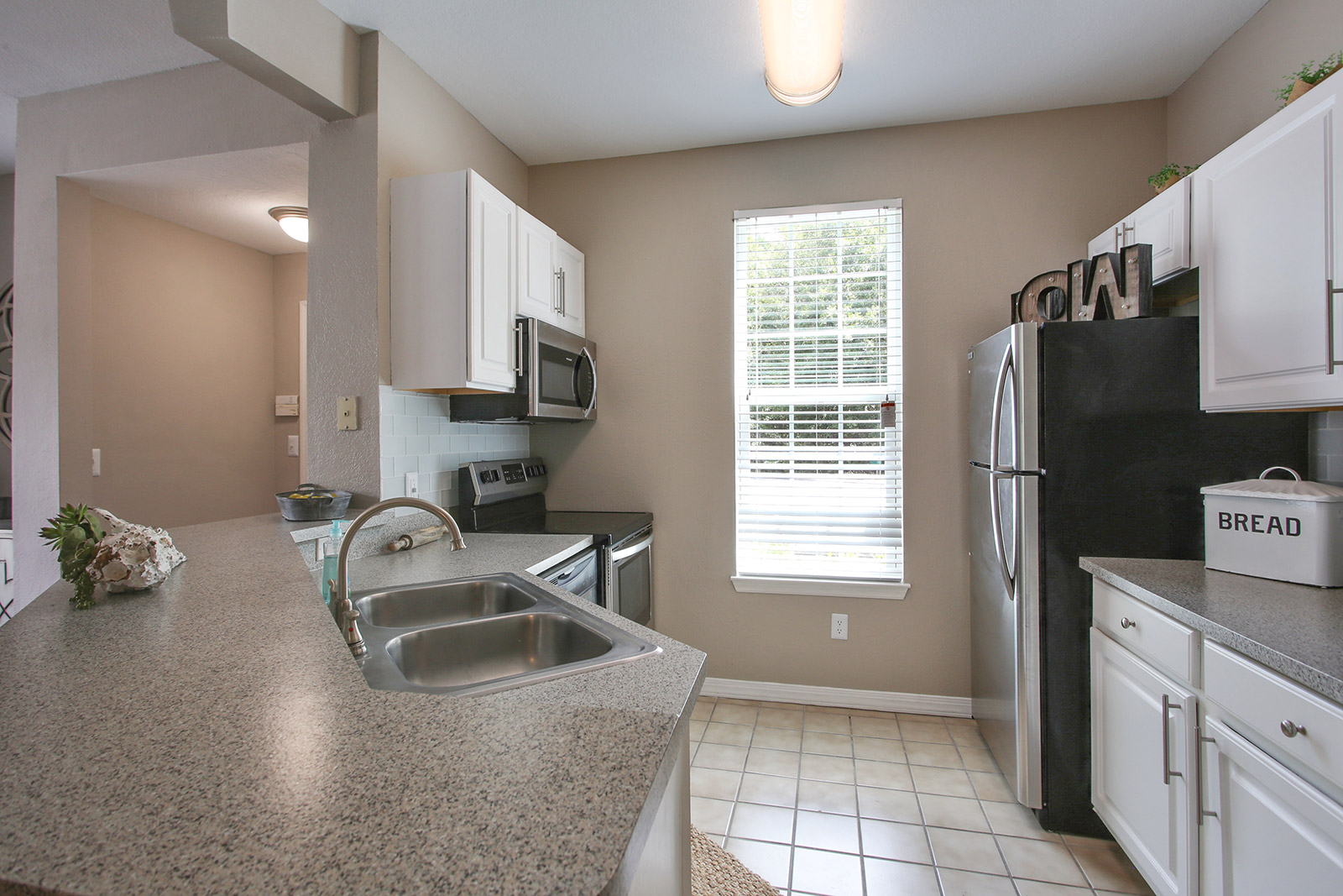 a kitchen with a sink and a mirror