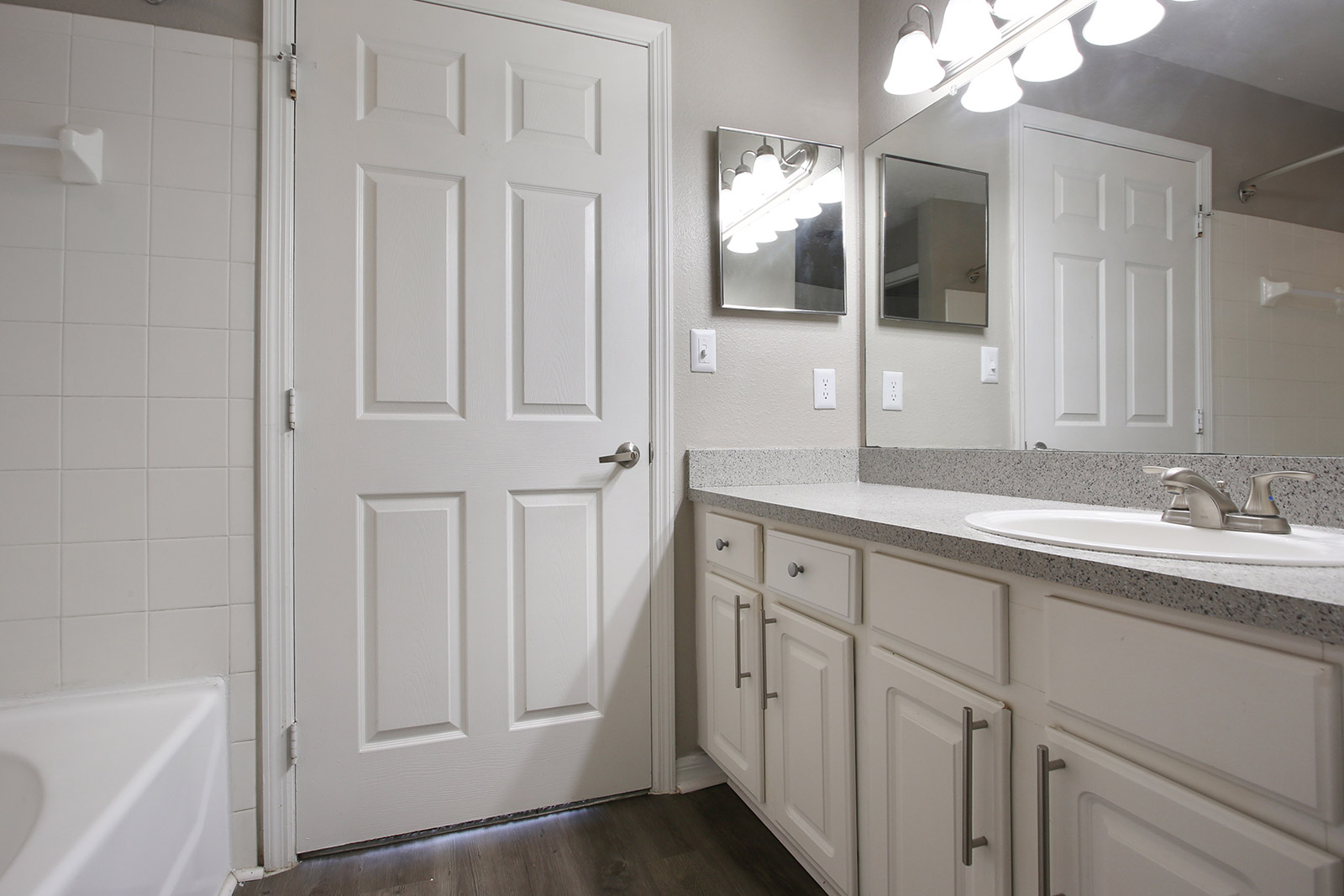 a kitchen with a sink and a mirror