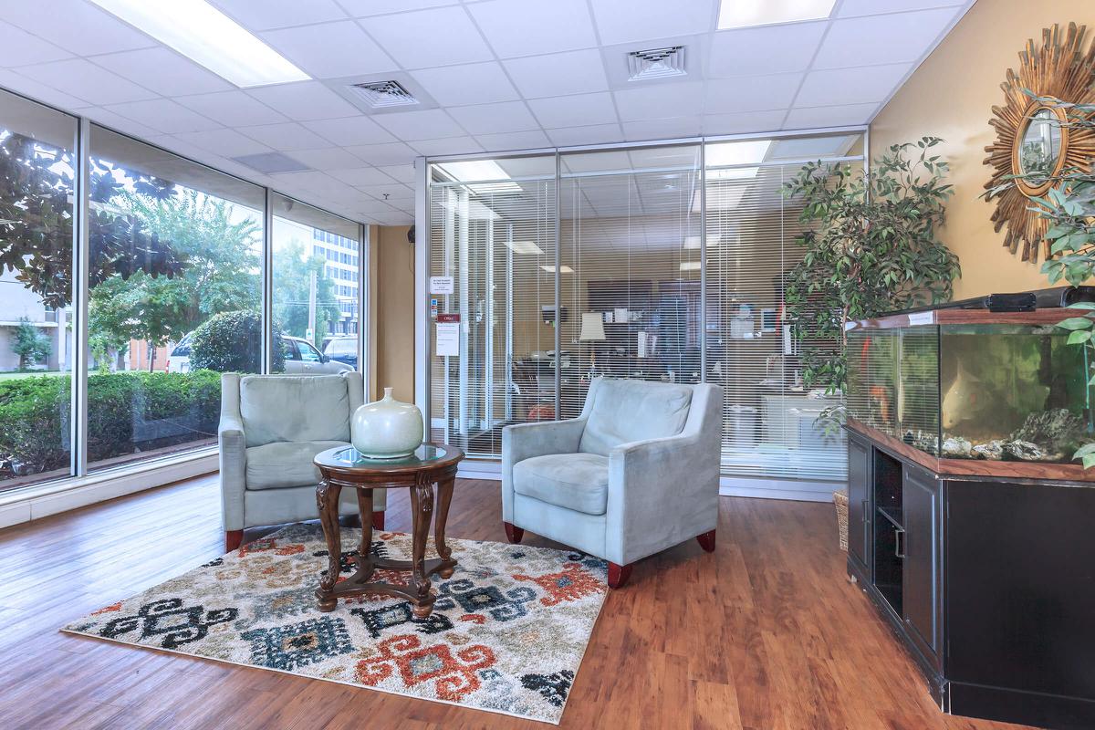 a living room filled with furniture and a large window