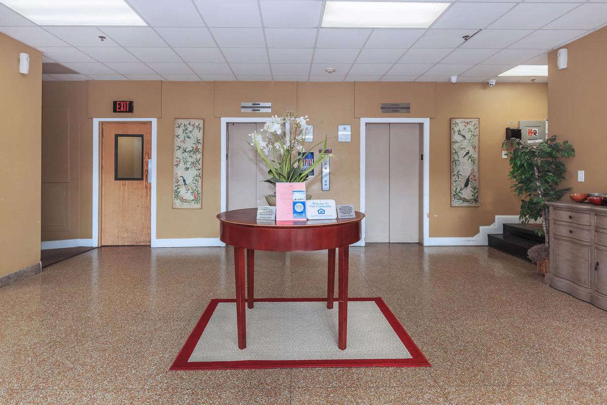 a living room filled with furniture and vase on a table