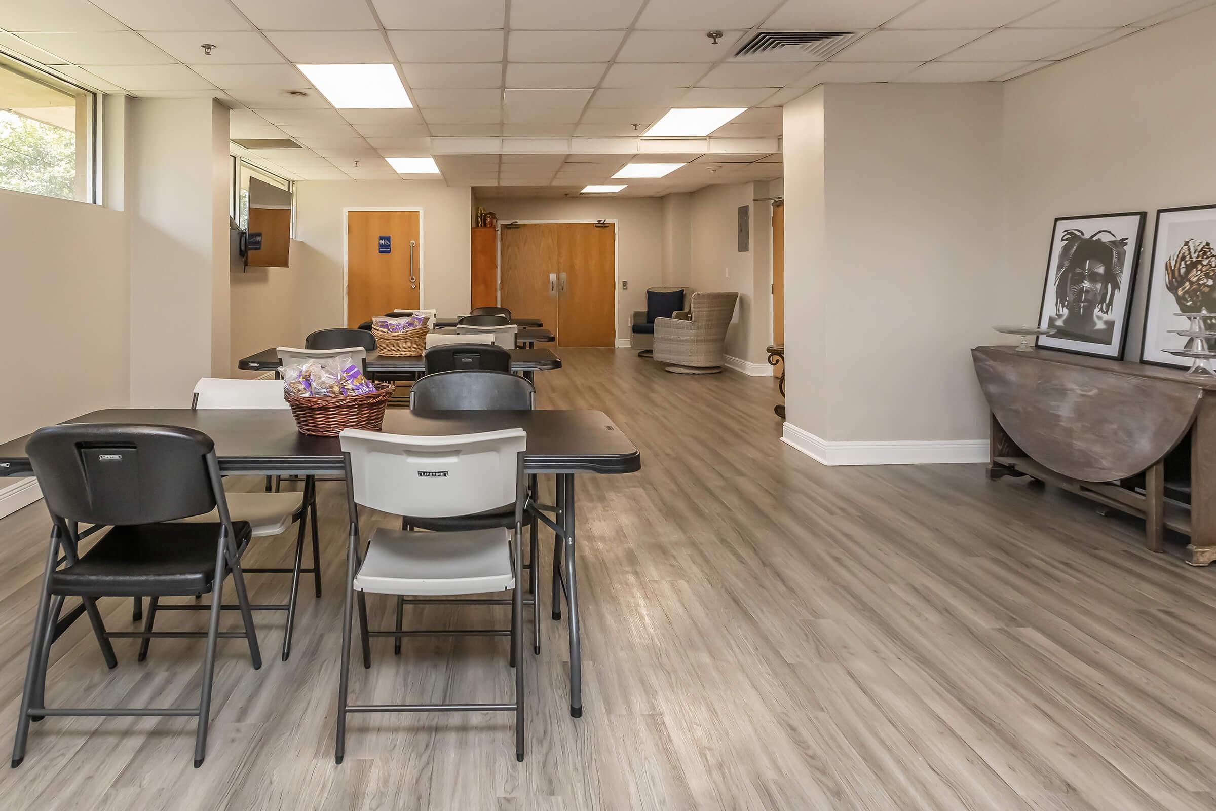 a room filled with furniture on top of a hard wood floor