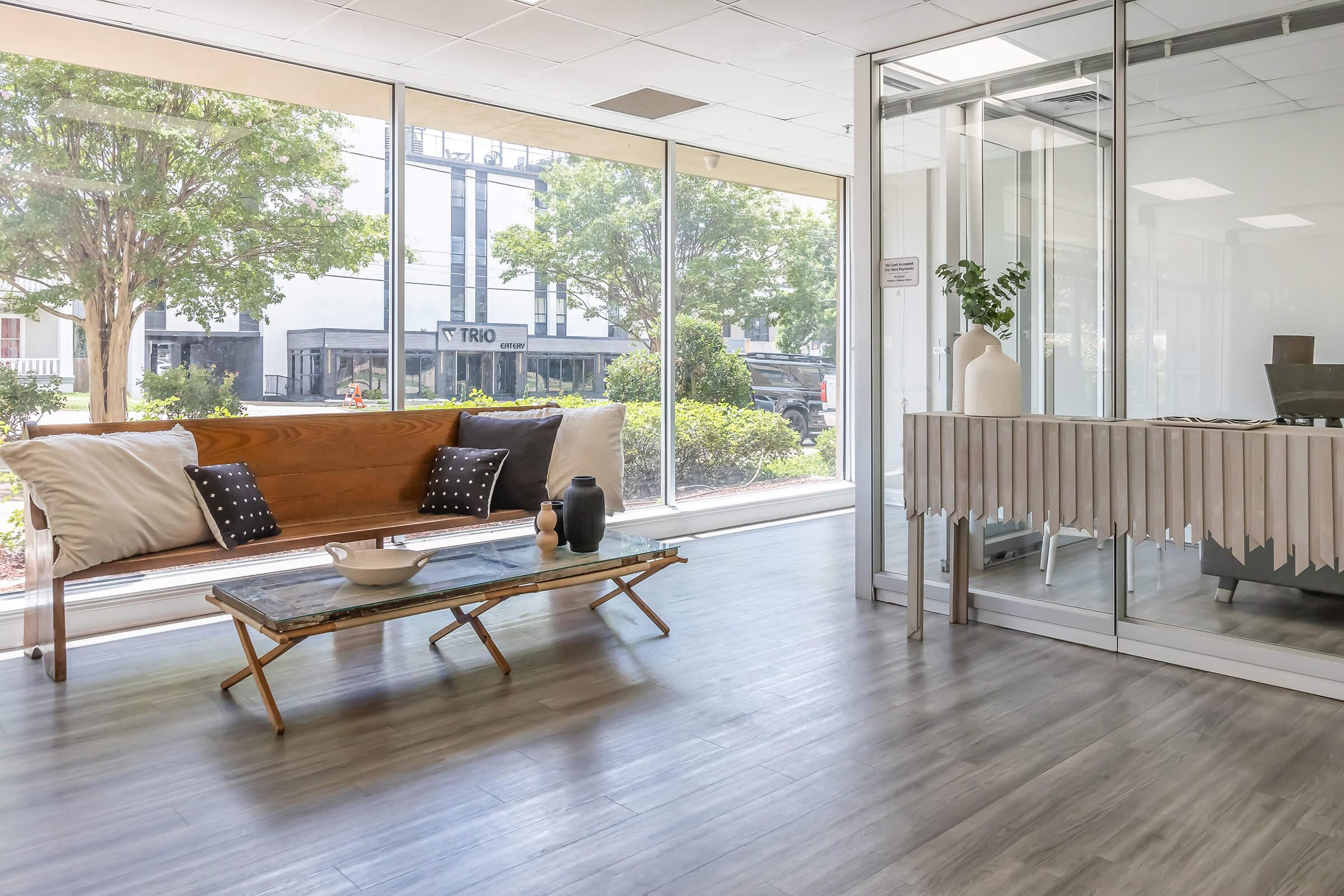 a living room filled with furniture and a large window