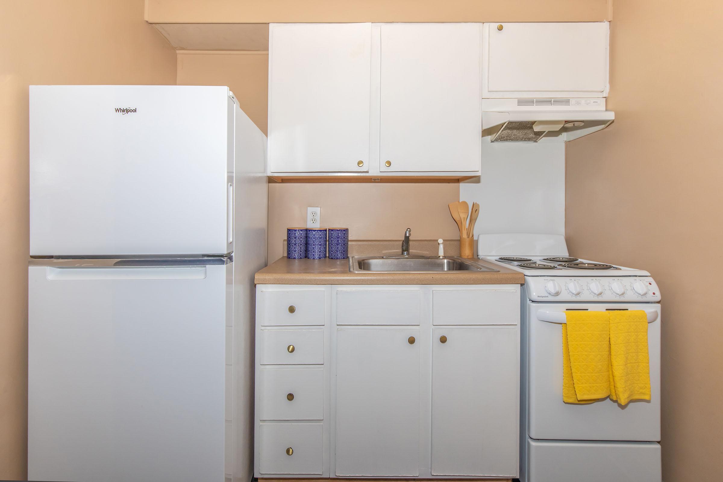 a kitchen with a stove top oven sitting inside of a refrigerator