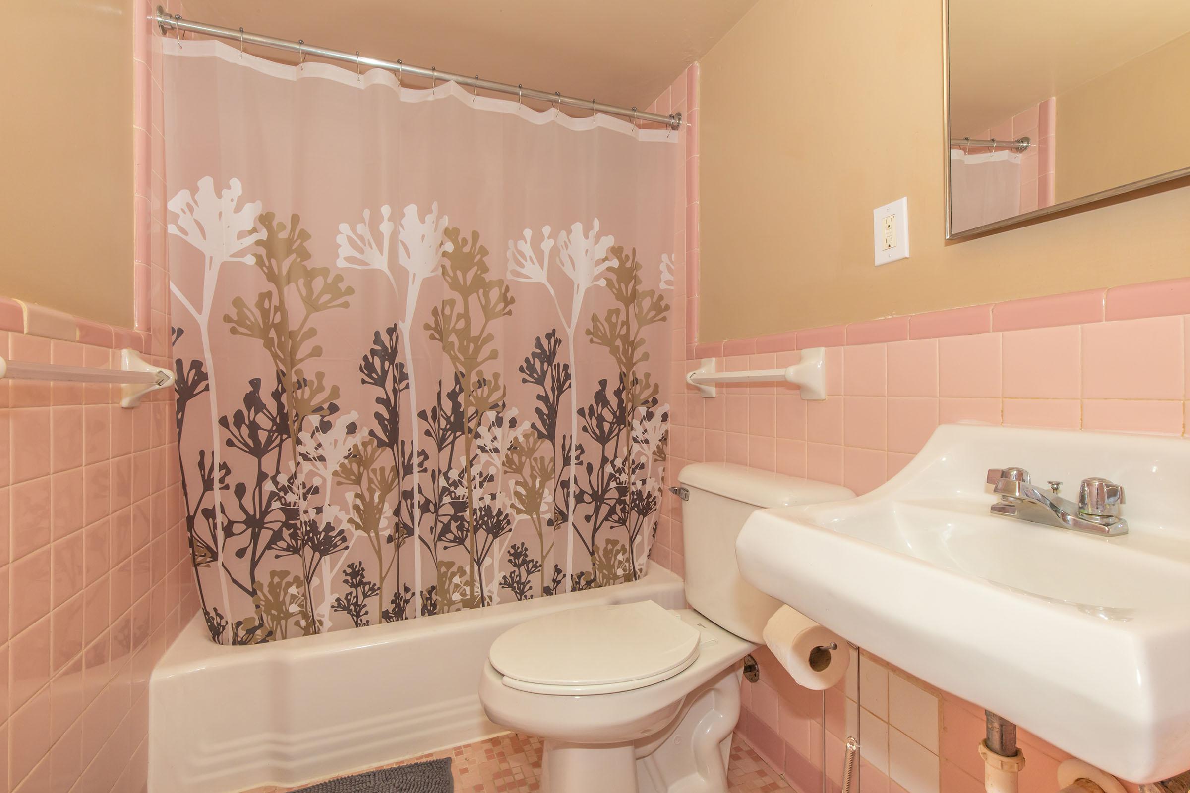 a close up of pink tub and sink