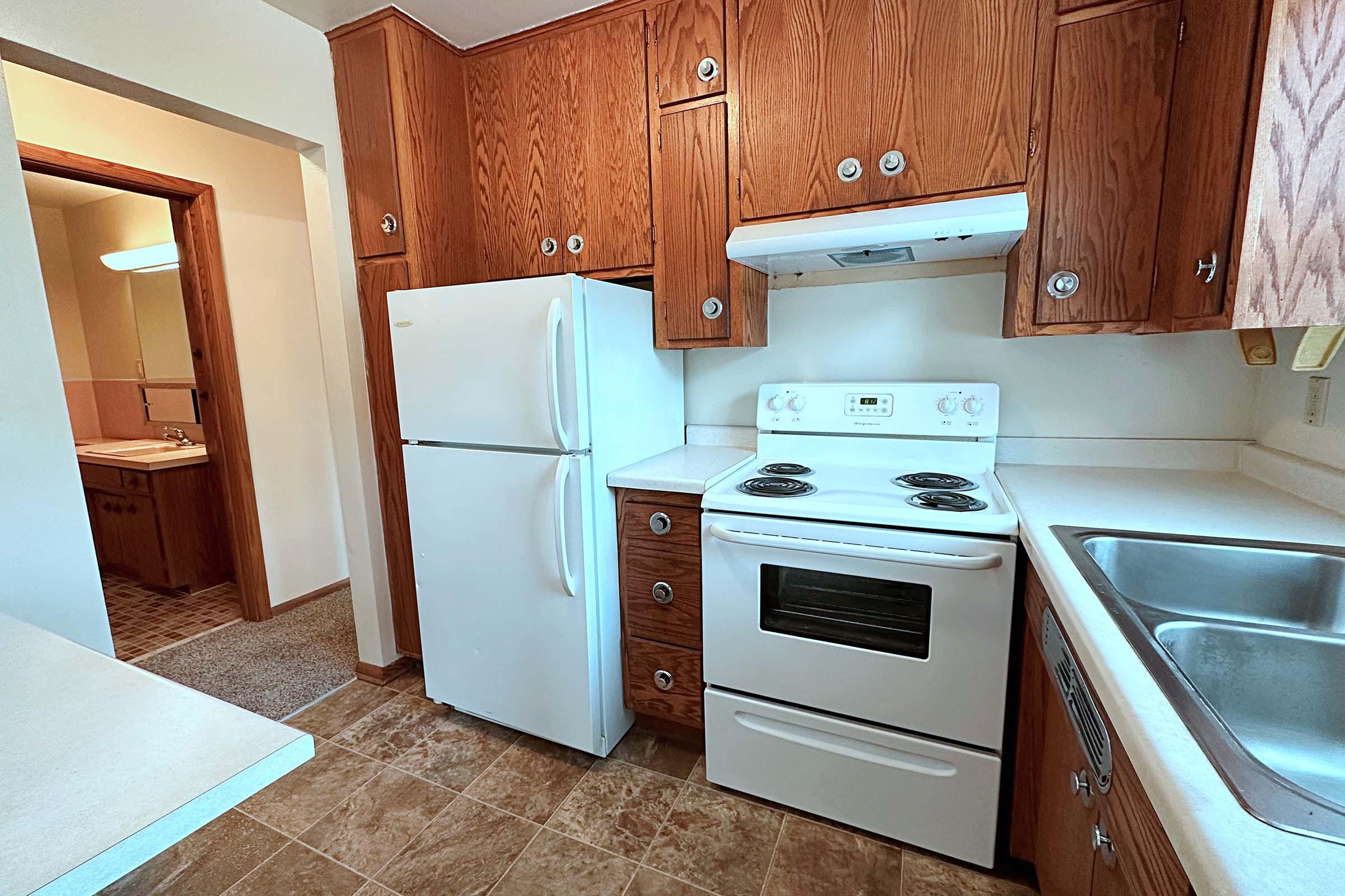 a kitchen with a stove top oven sitting inside of a refrigerator