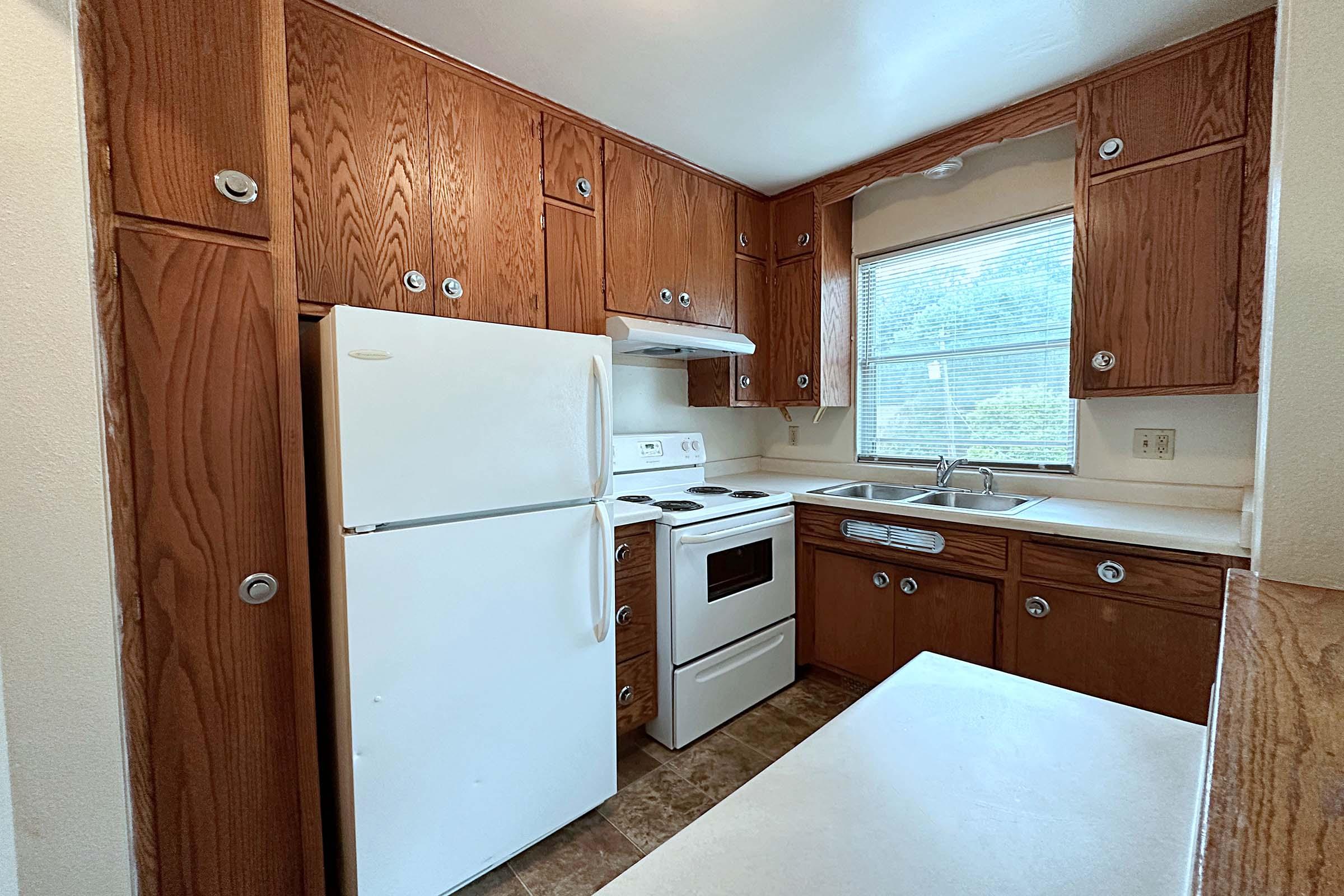 a kitchen with a stove top oven sitting inside of a refrigerator