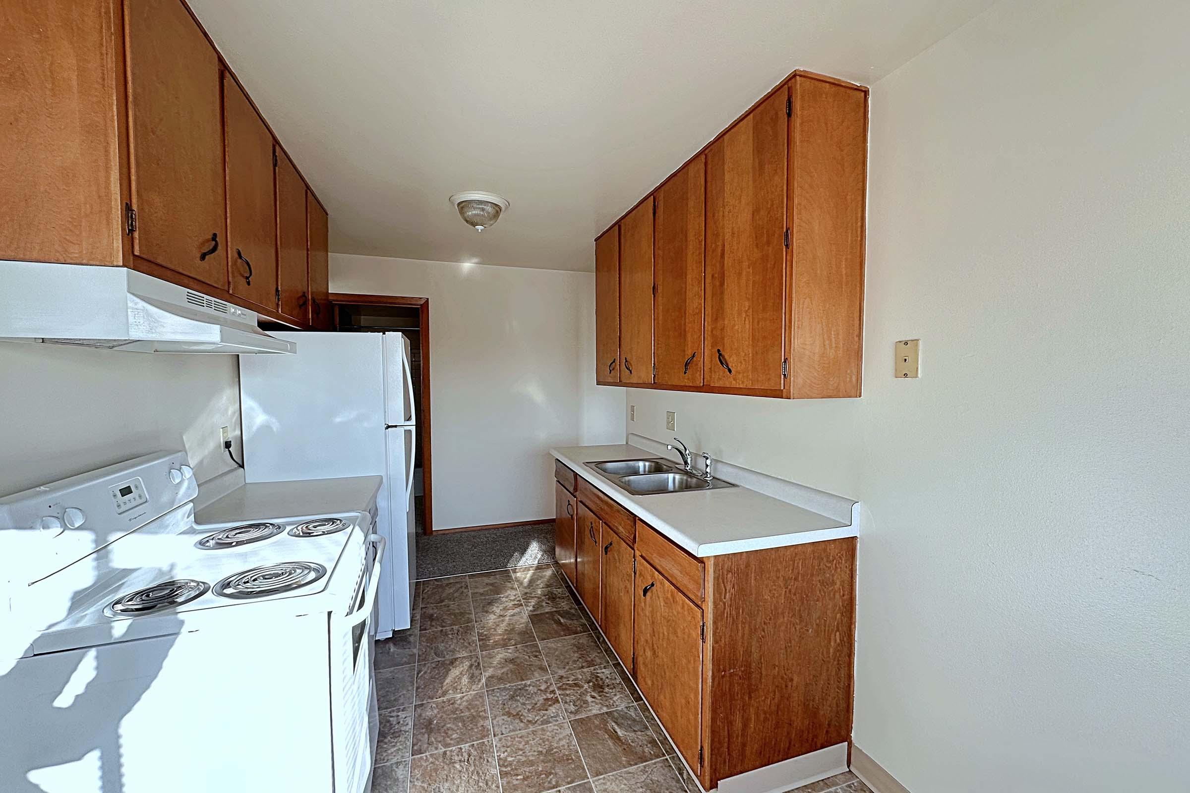 a kitchen with a sink and a refrigerator