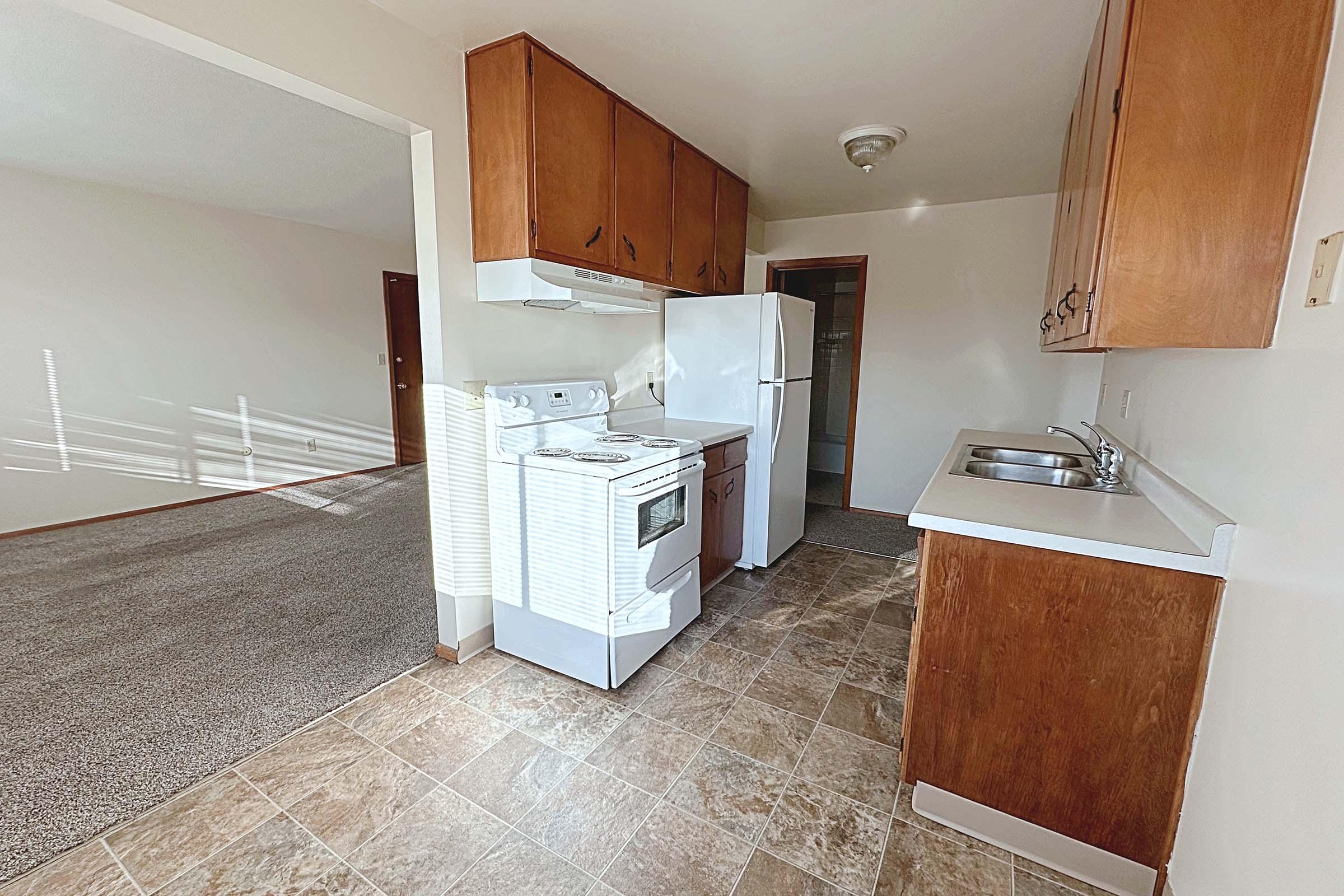 a kitchen with a sink and a refrigerator