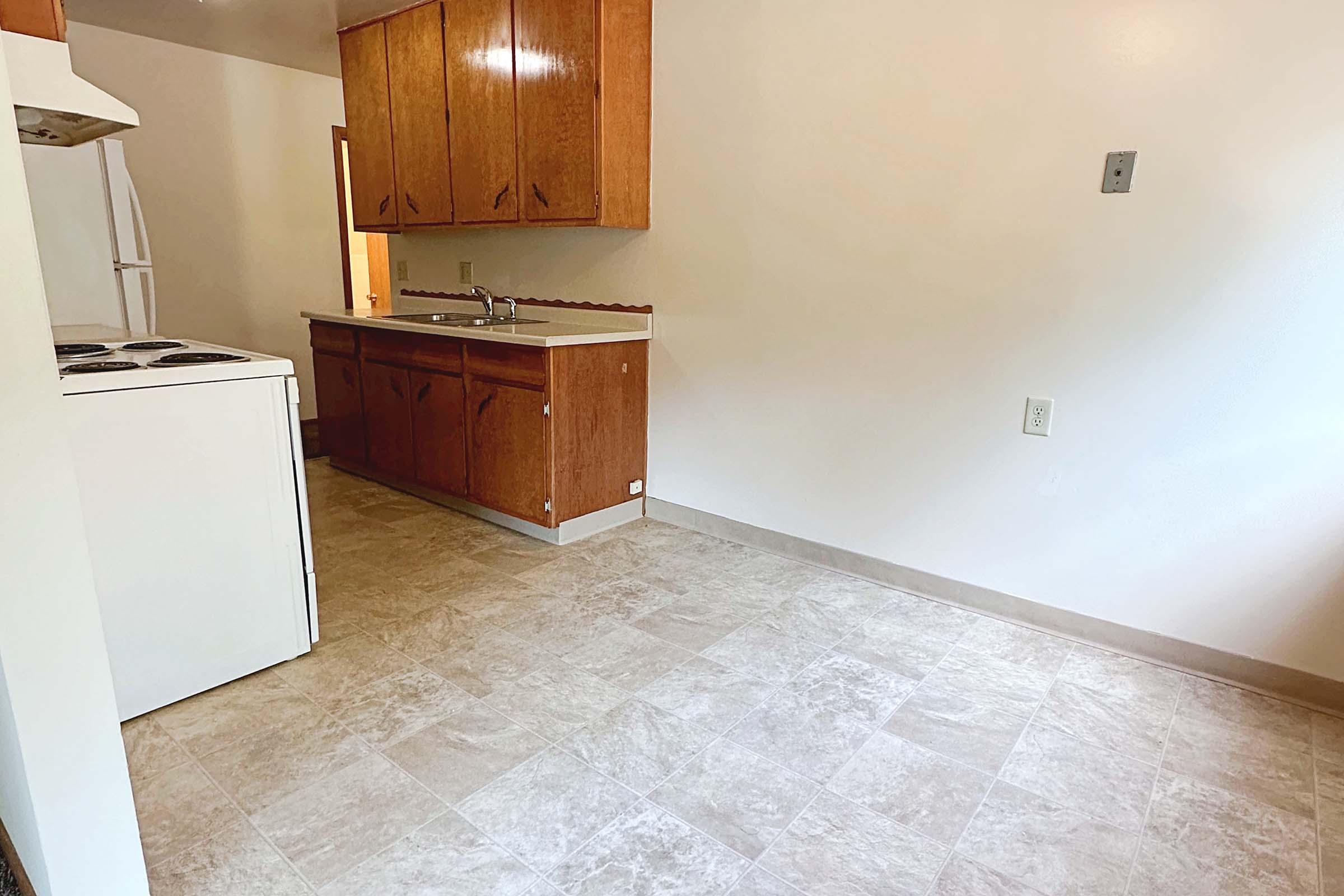 a kitchen with a sink and a refrigerator