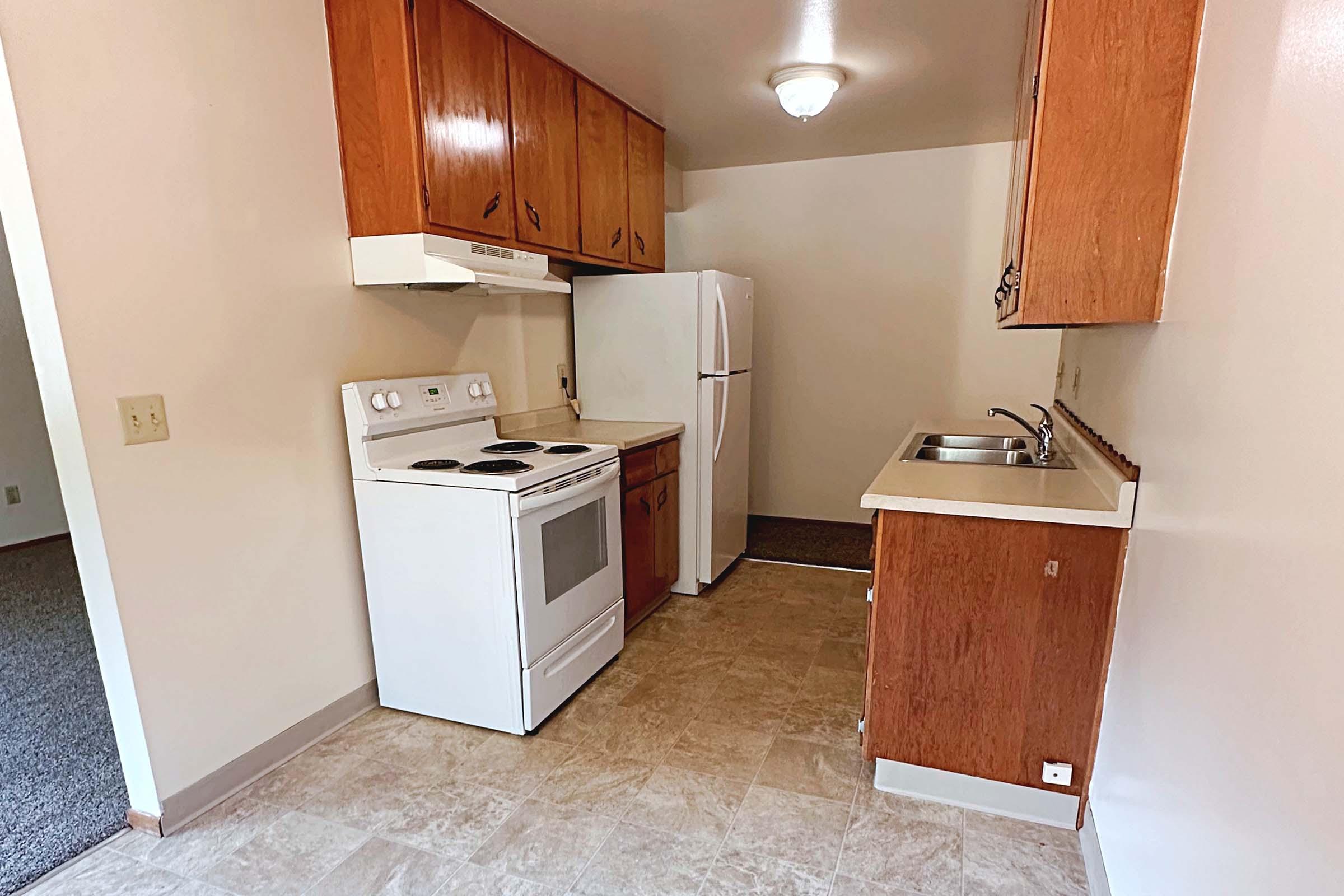 a kitchen with a sink and a refrigerator