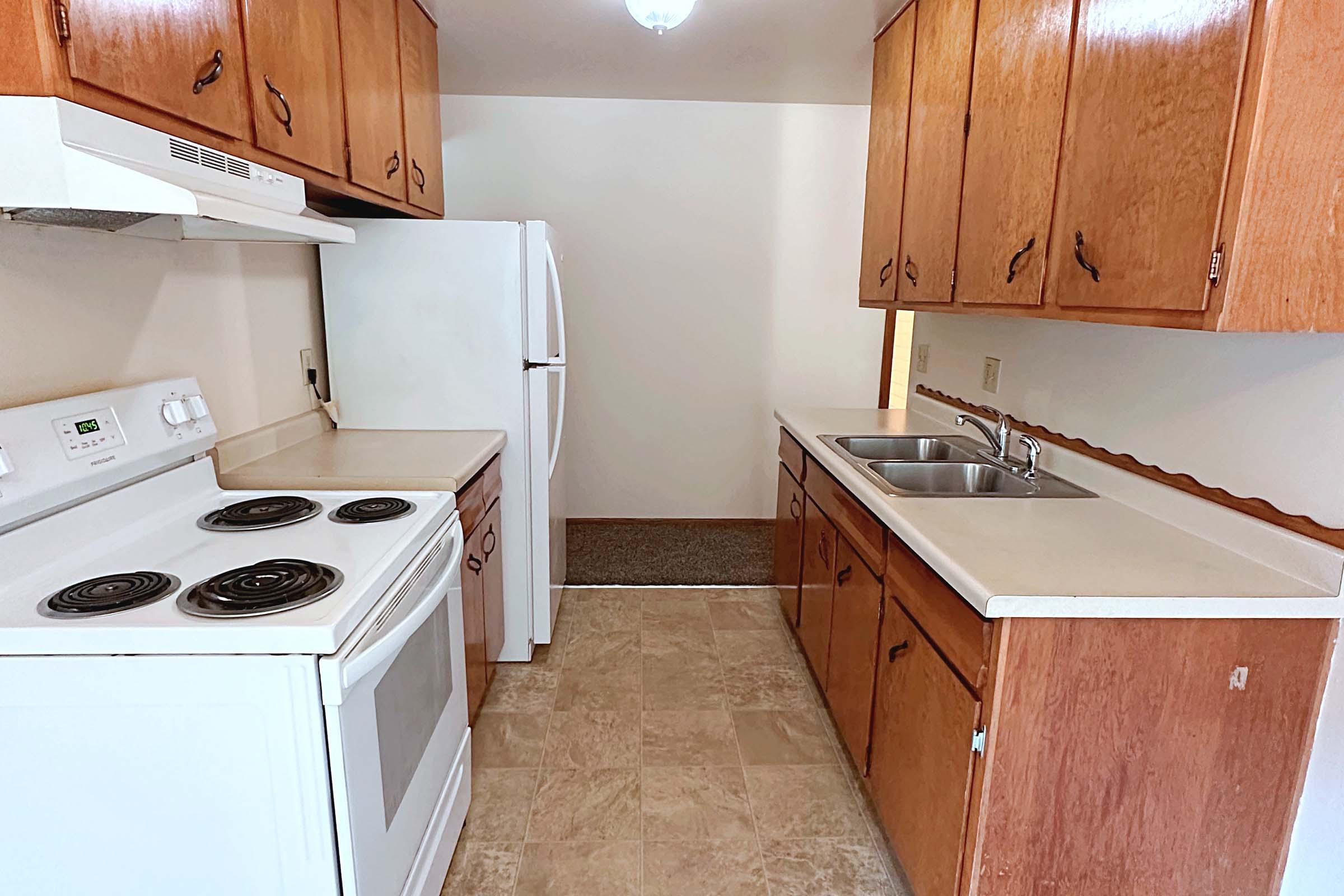 a kitchen with a stove top oven sitting inside of a refrigerator