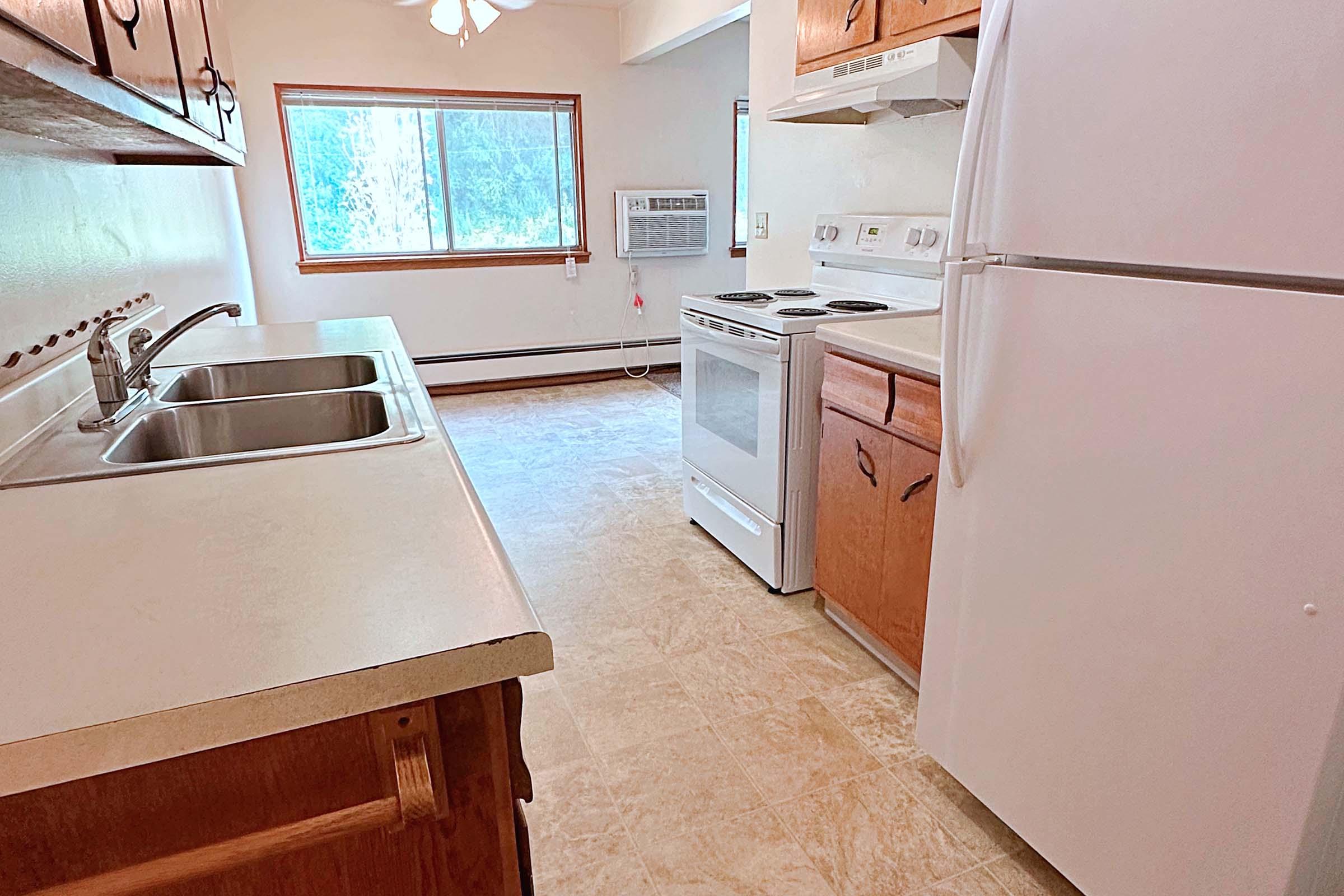 a kitchen with a stove and a refrigerator