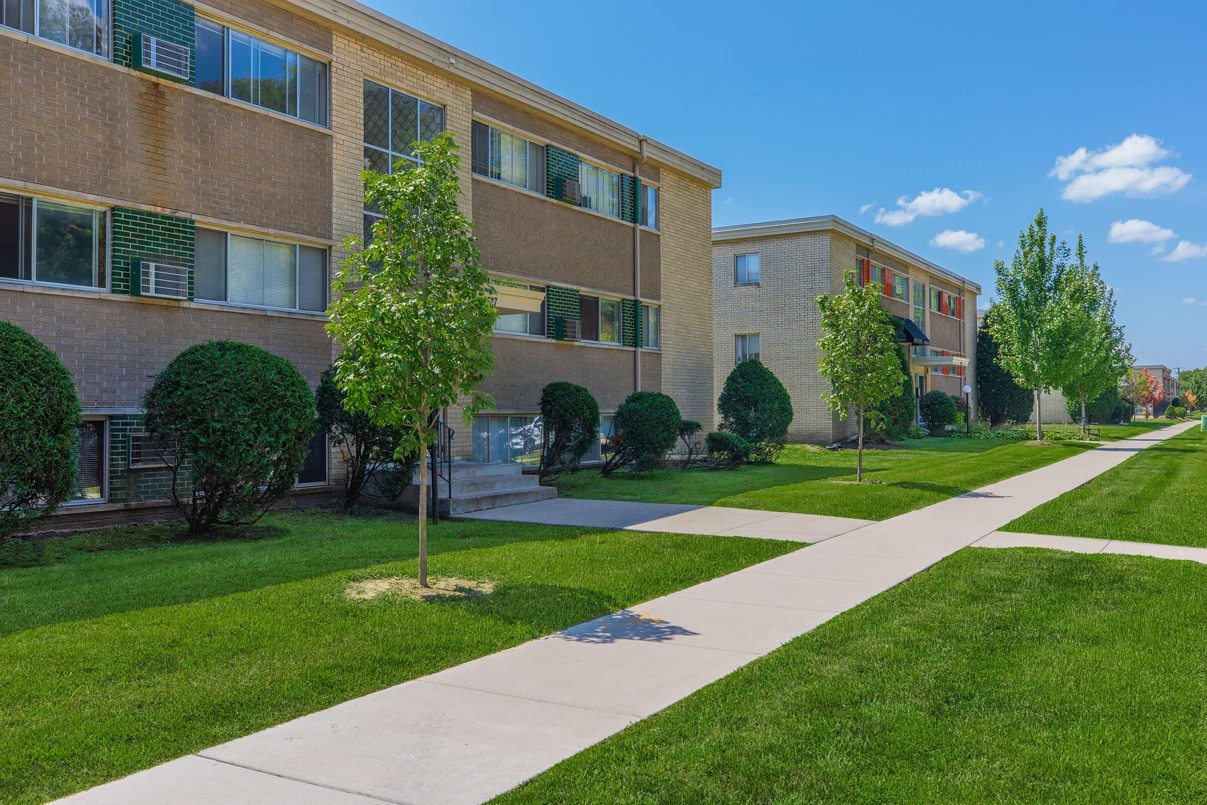 a large lawn in front of a brick building