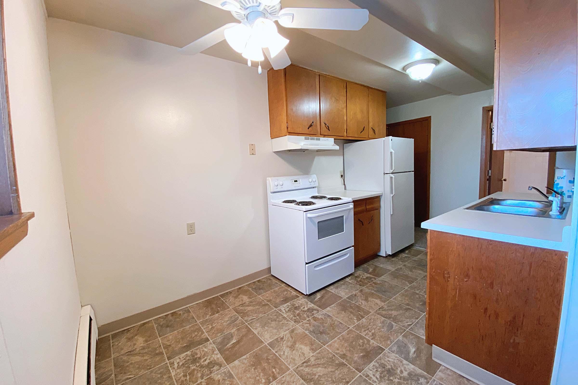 a kitchen with a stove sink and refrigerator