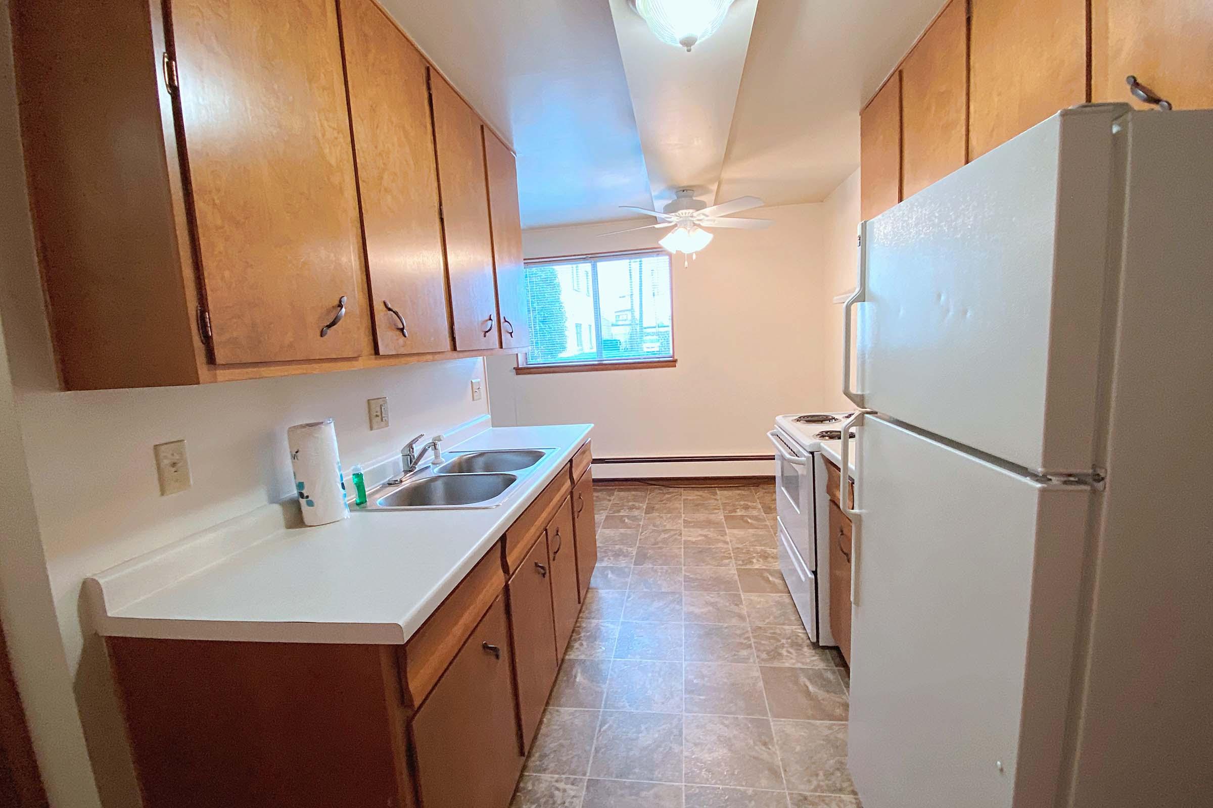 a kitchen with a sink and a refrigerator