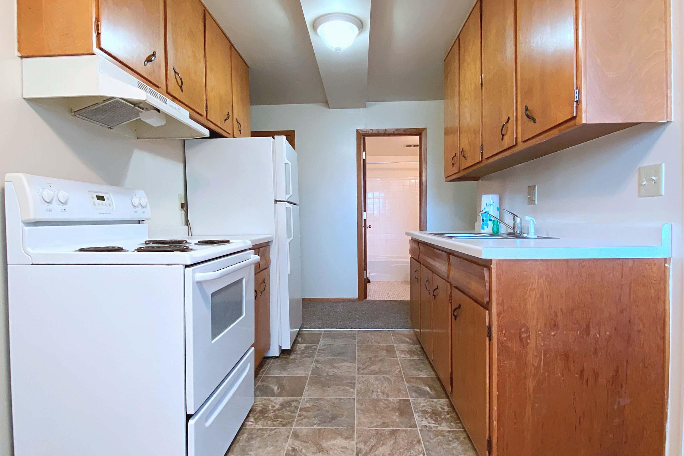 a kitchen with a stove top oven sitting inside of a refrigerator