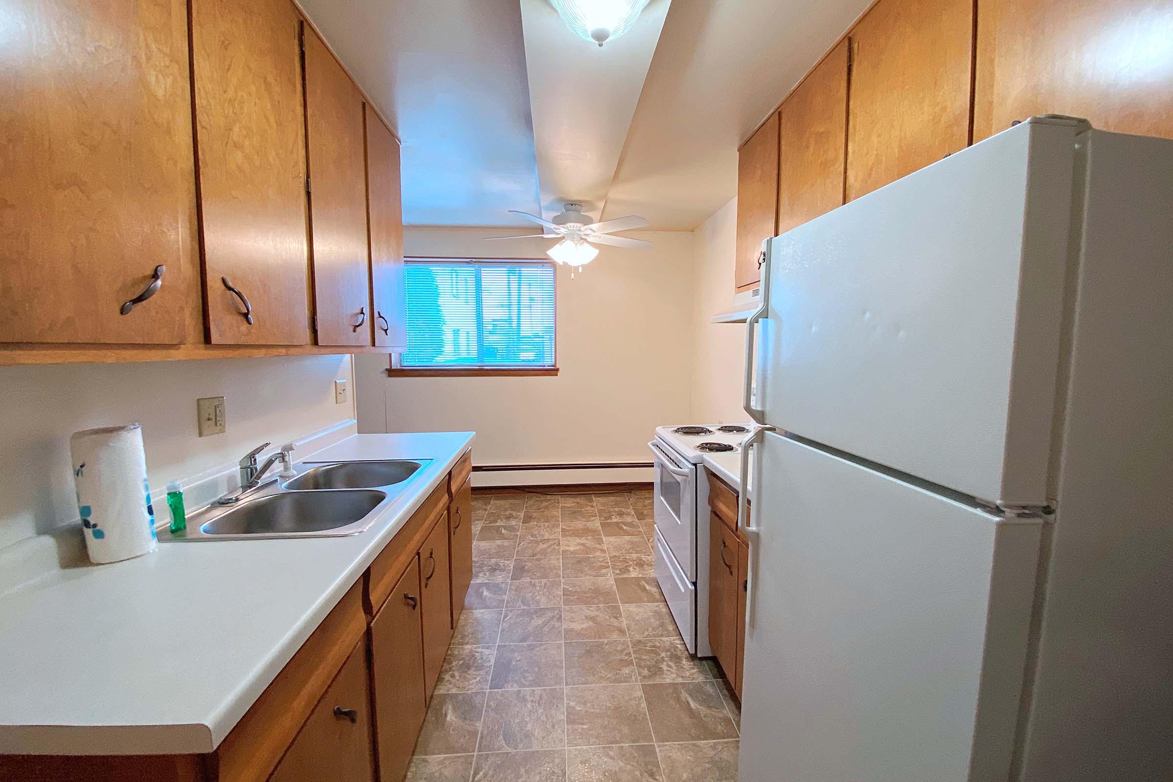 a kitchen with a stove sink and refrigerator