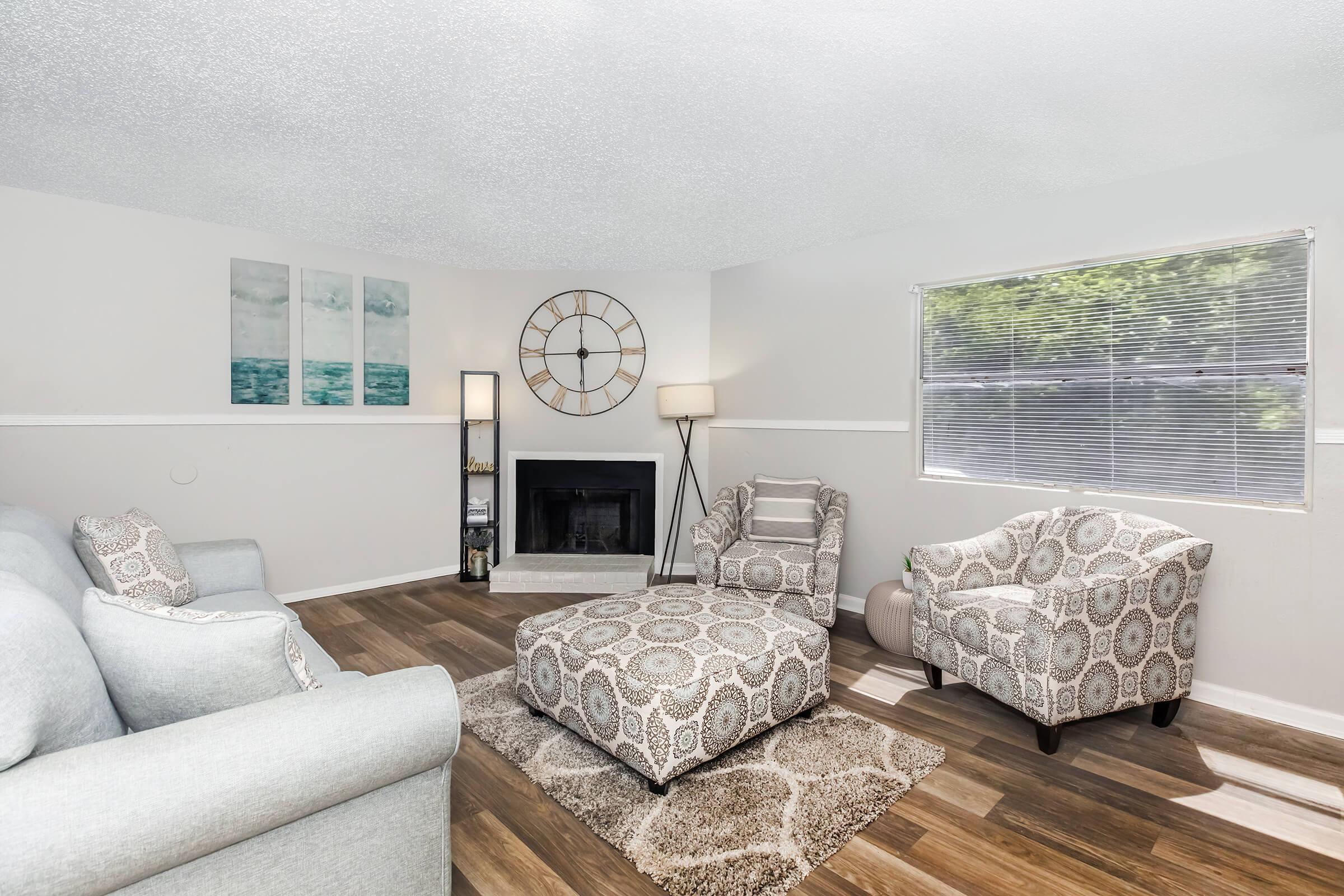 a living room filled with furniture and a flat screen tv