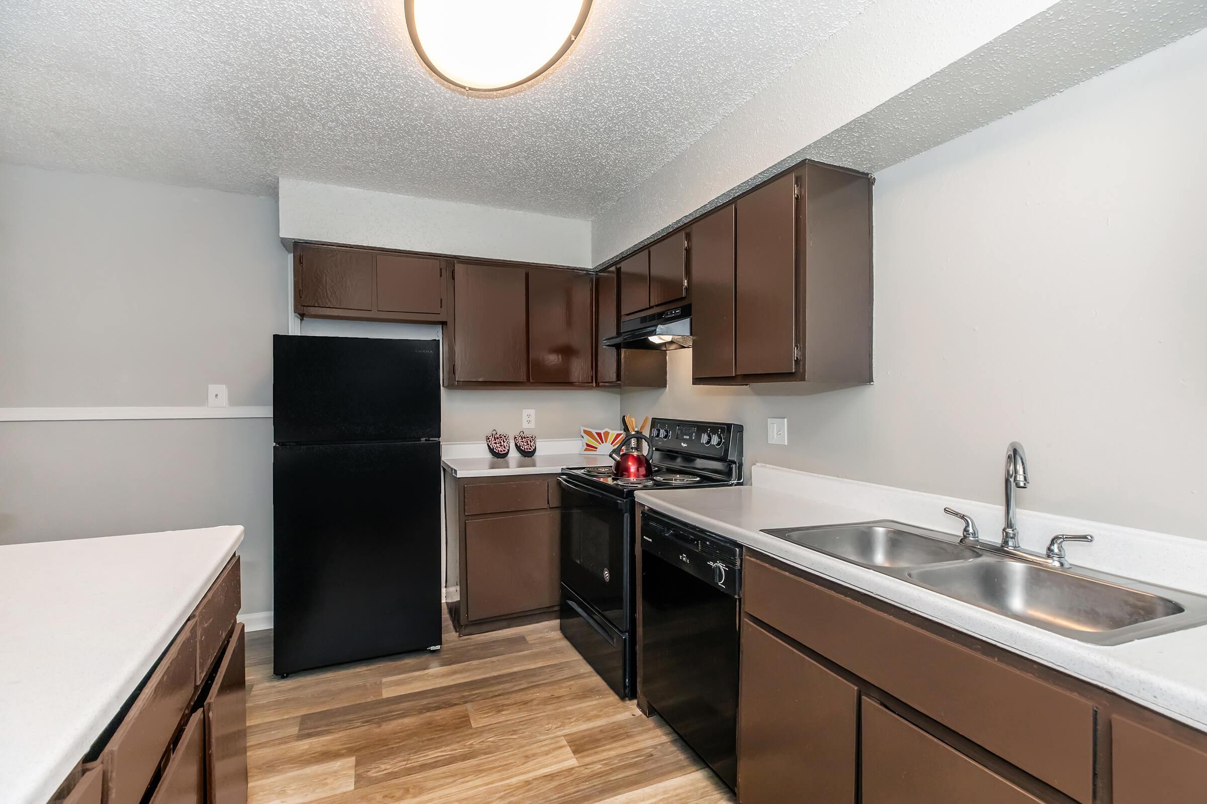 a kitchen with a sink and a mirror