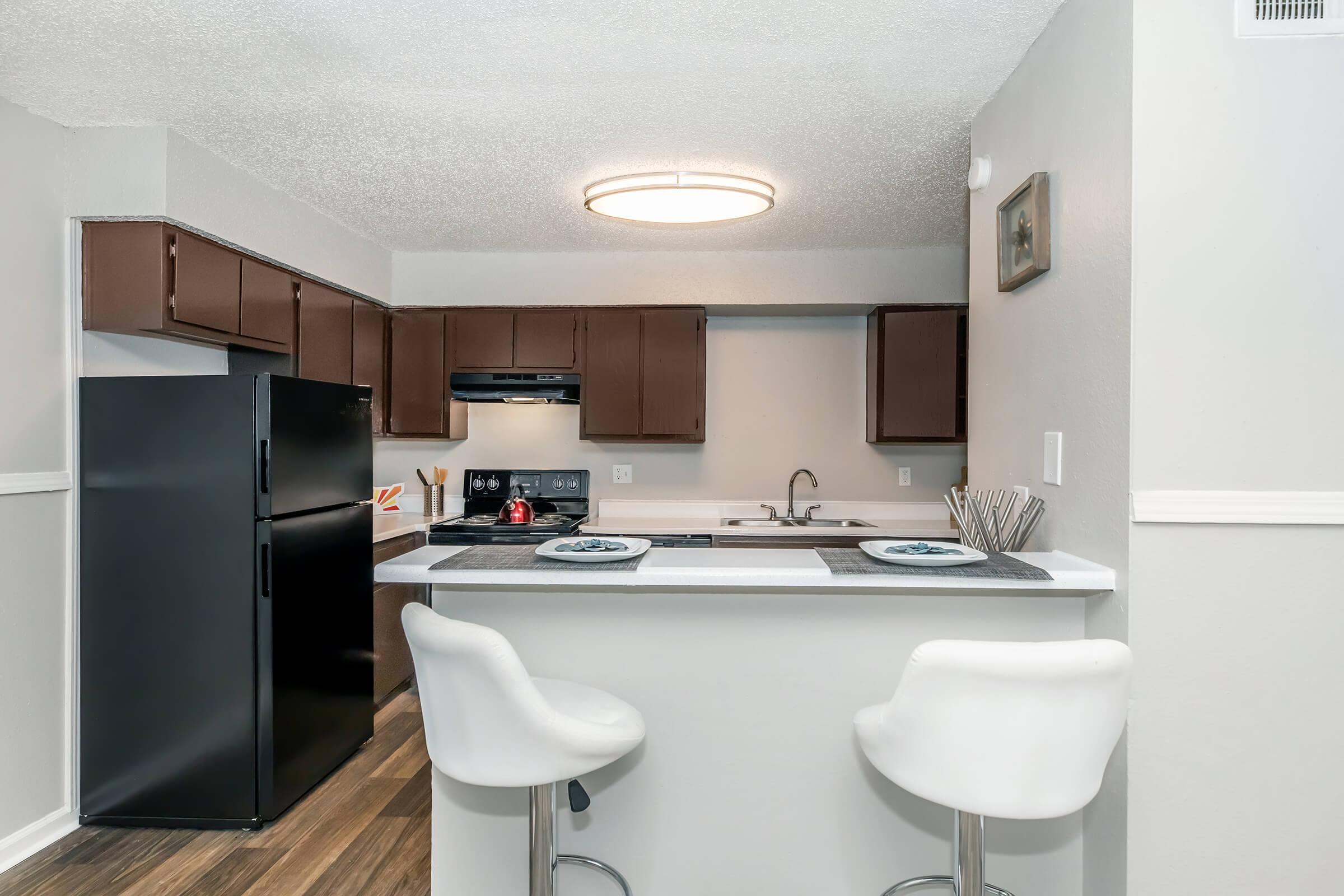 a kitchen with a sink and a mirror