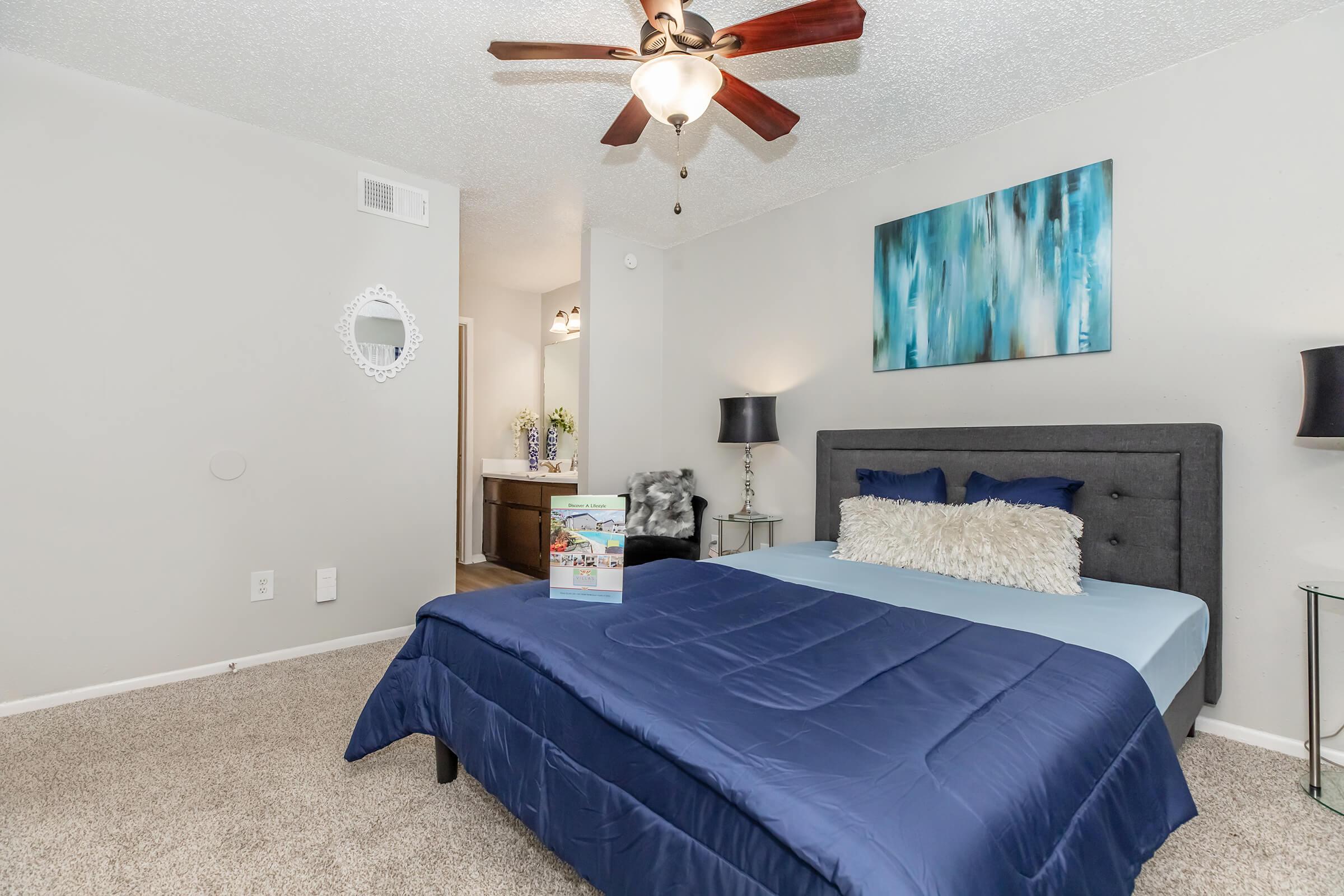 a bedroom with a bed and desk in a room