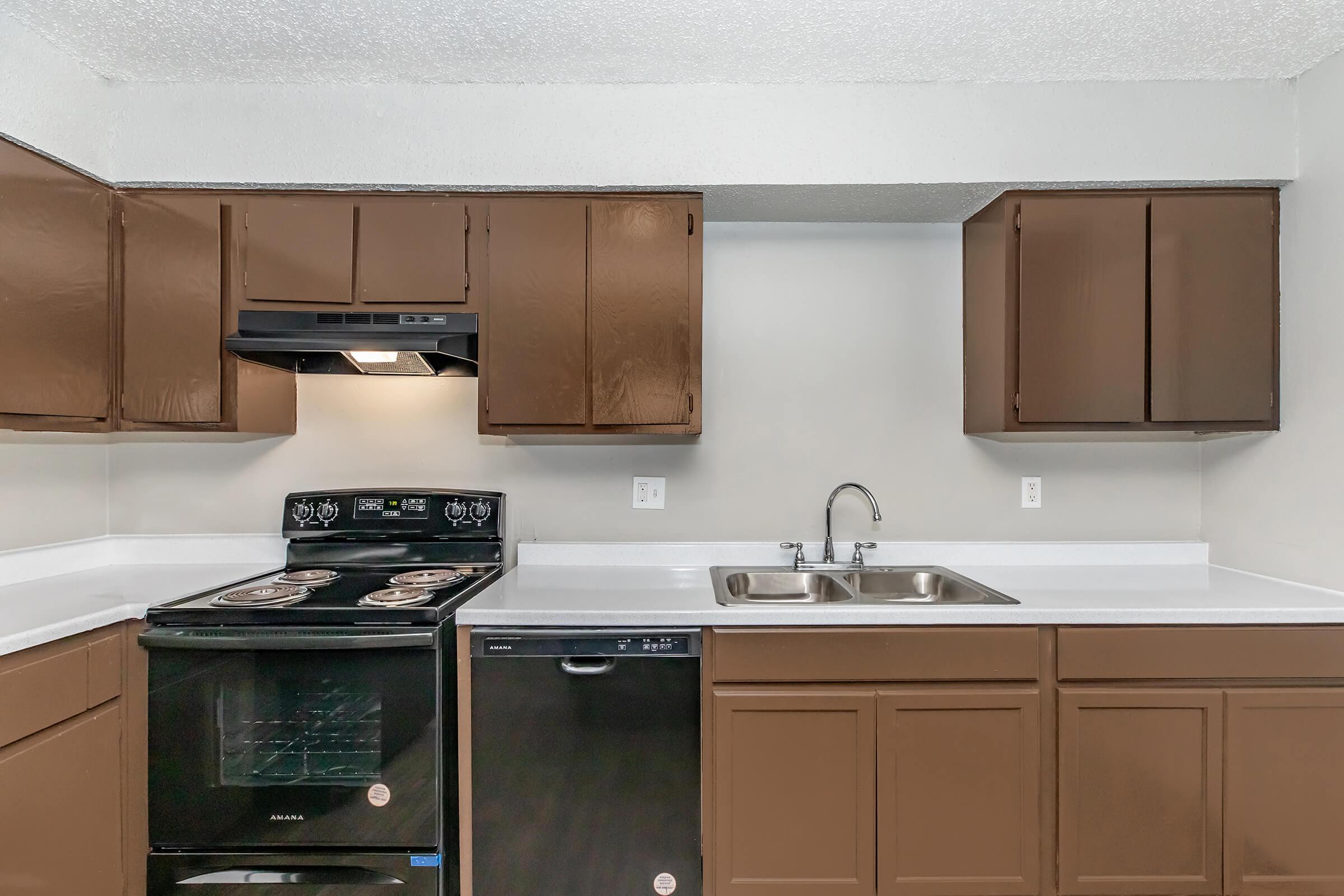 a kitchen with a stove a sink and a microwave