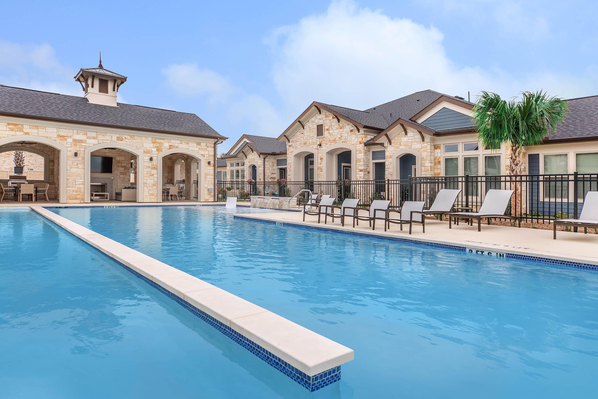 a large pool of water in front of a house