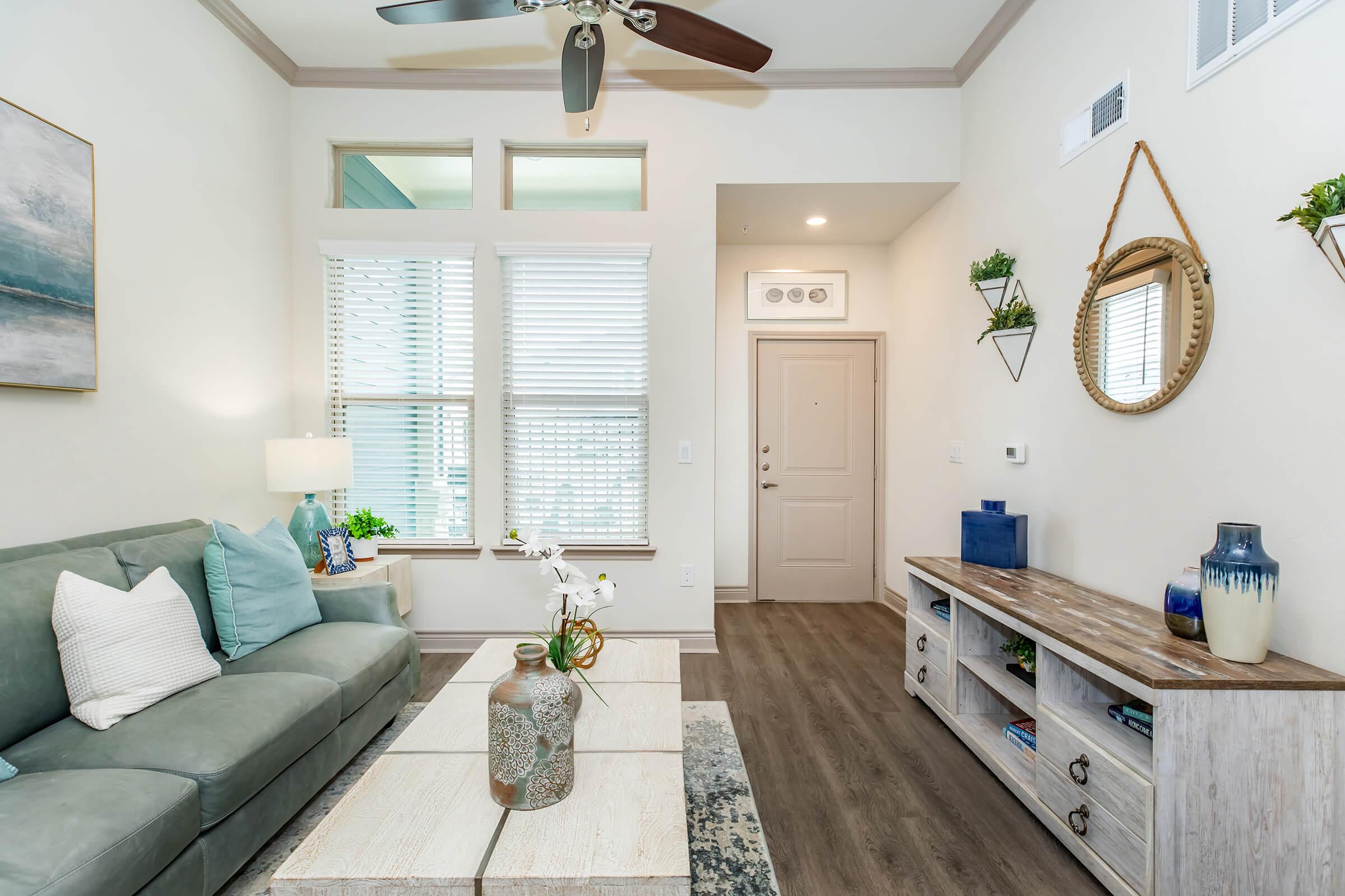 a living room filled with furniture and a large window