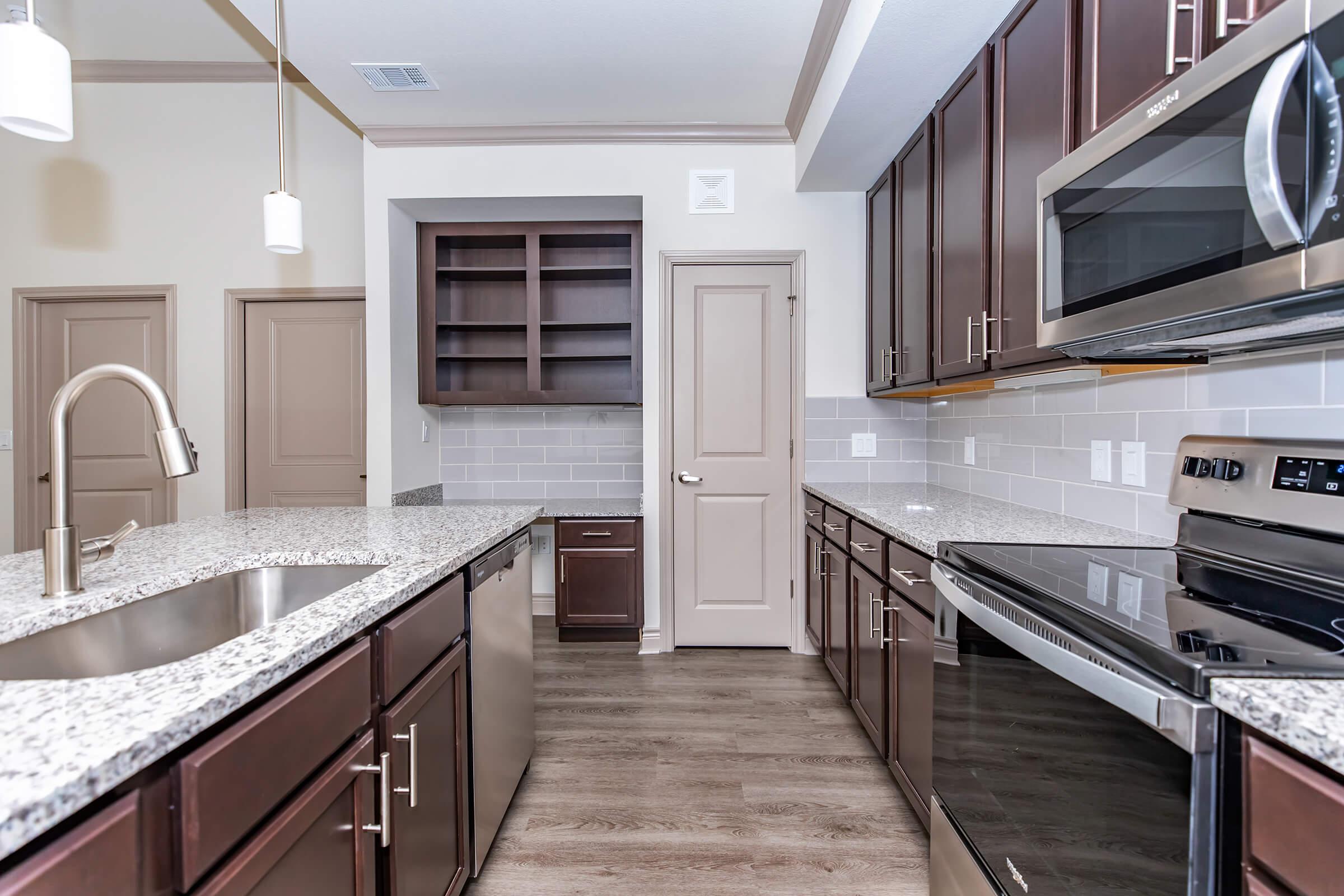 a modern kitchen with stainless steel appliances and wooden cabinets