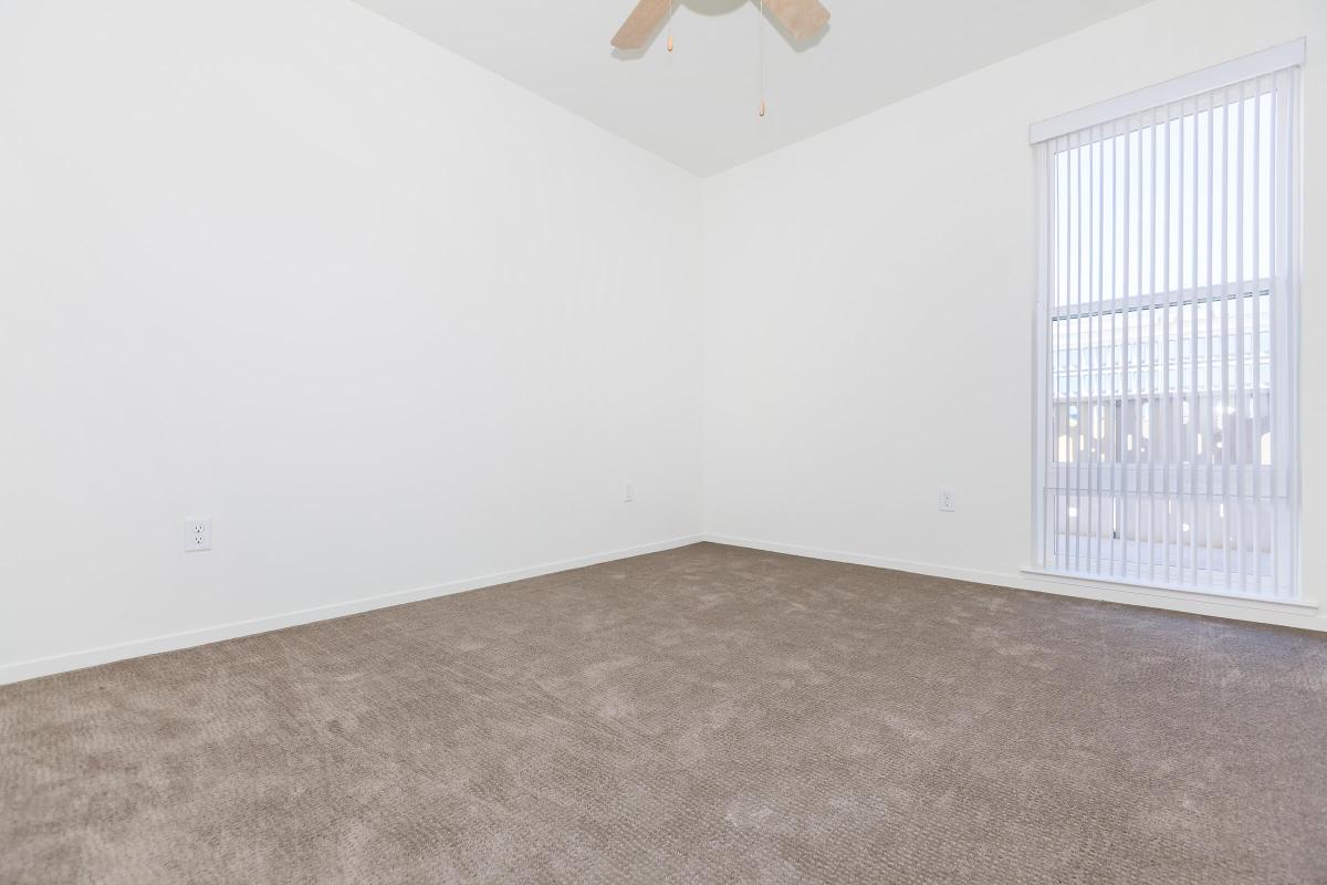 Unfurnished bedroom with brown carpet