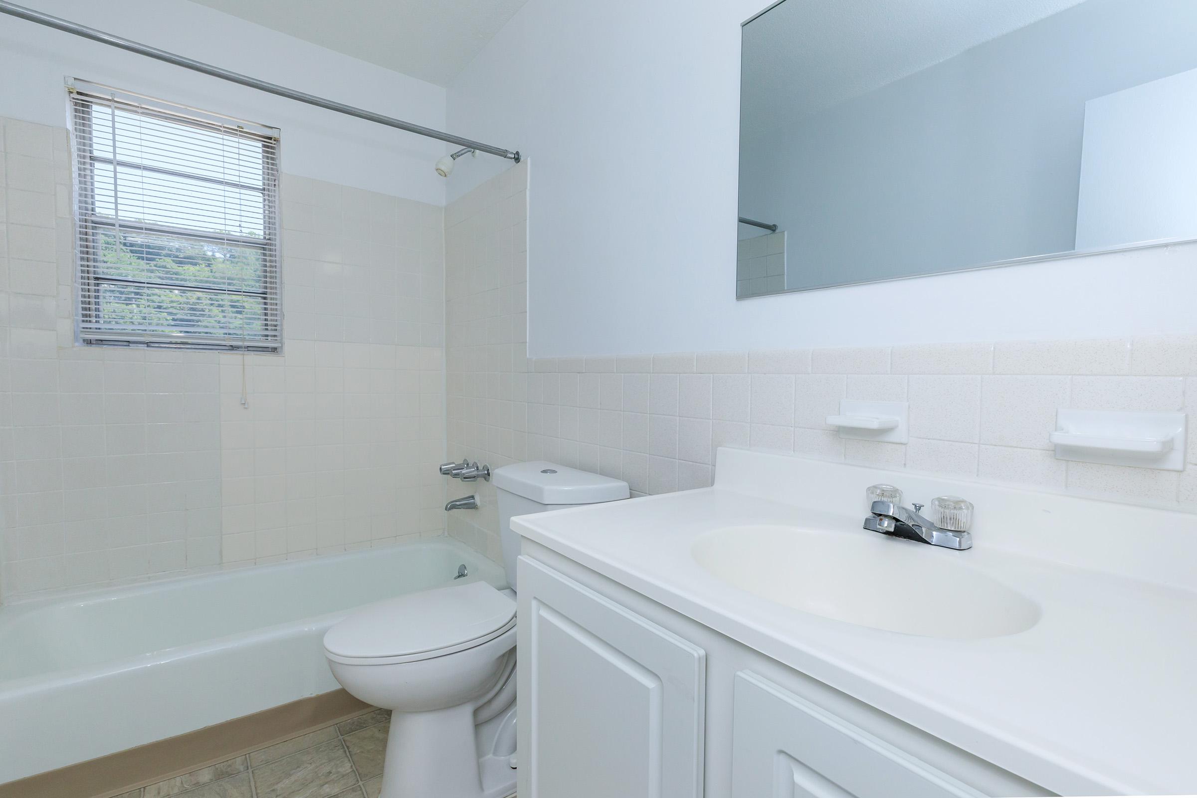 a white tub sitting next to a sink
