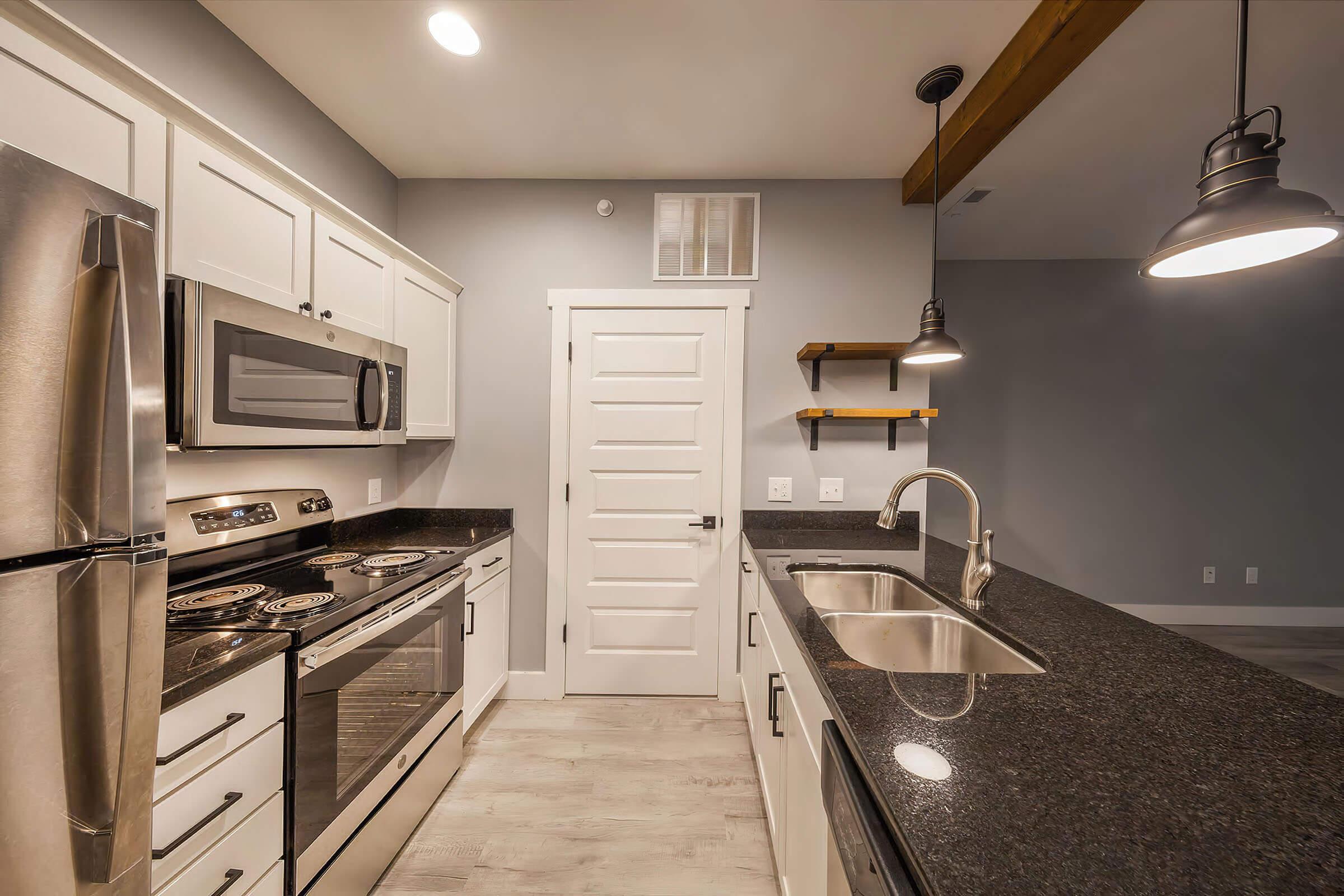 a stove top oven sitting inside of a kitchen