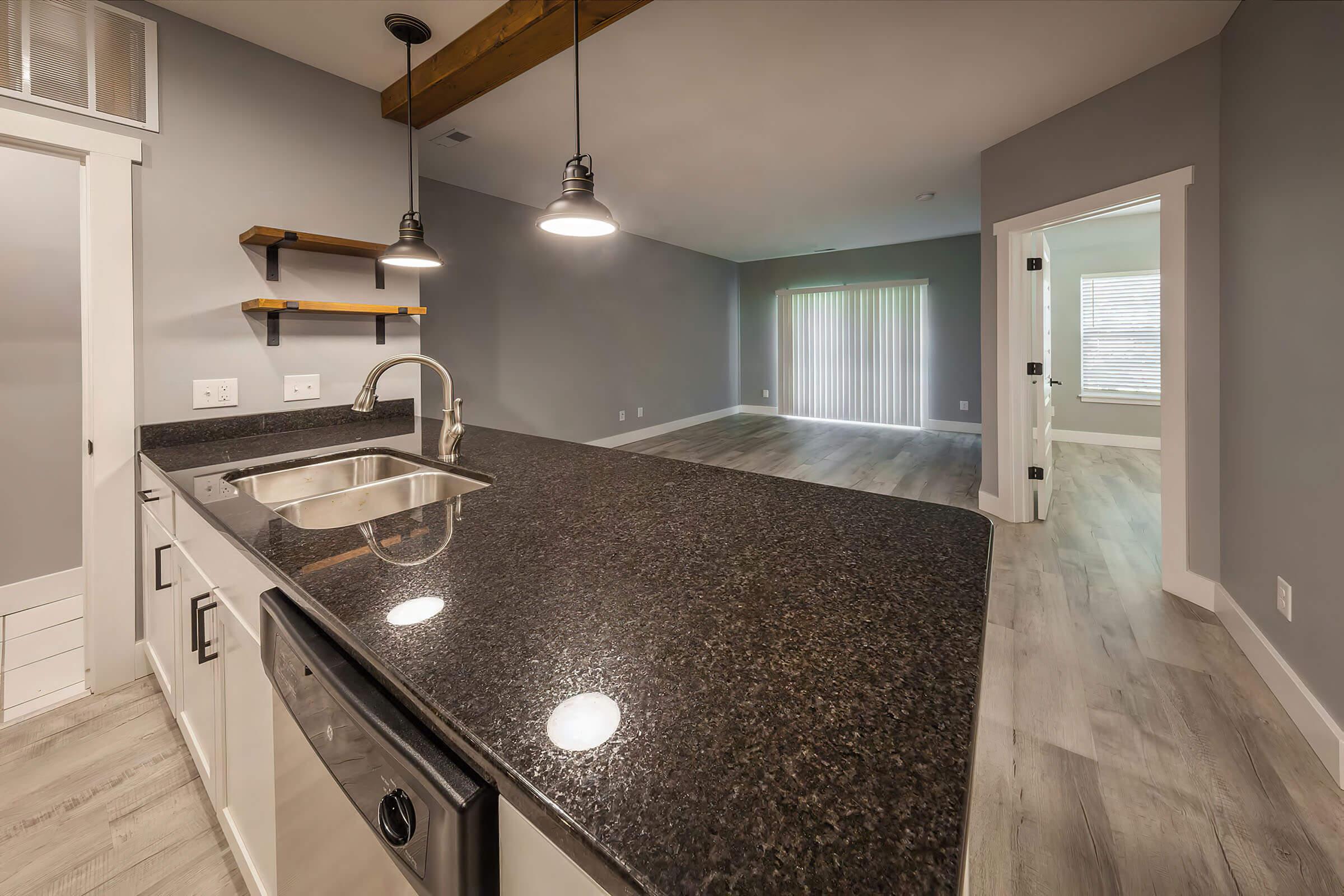 a kitchen with a sink and a mirror