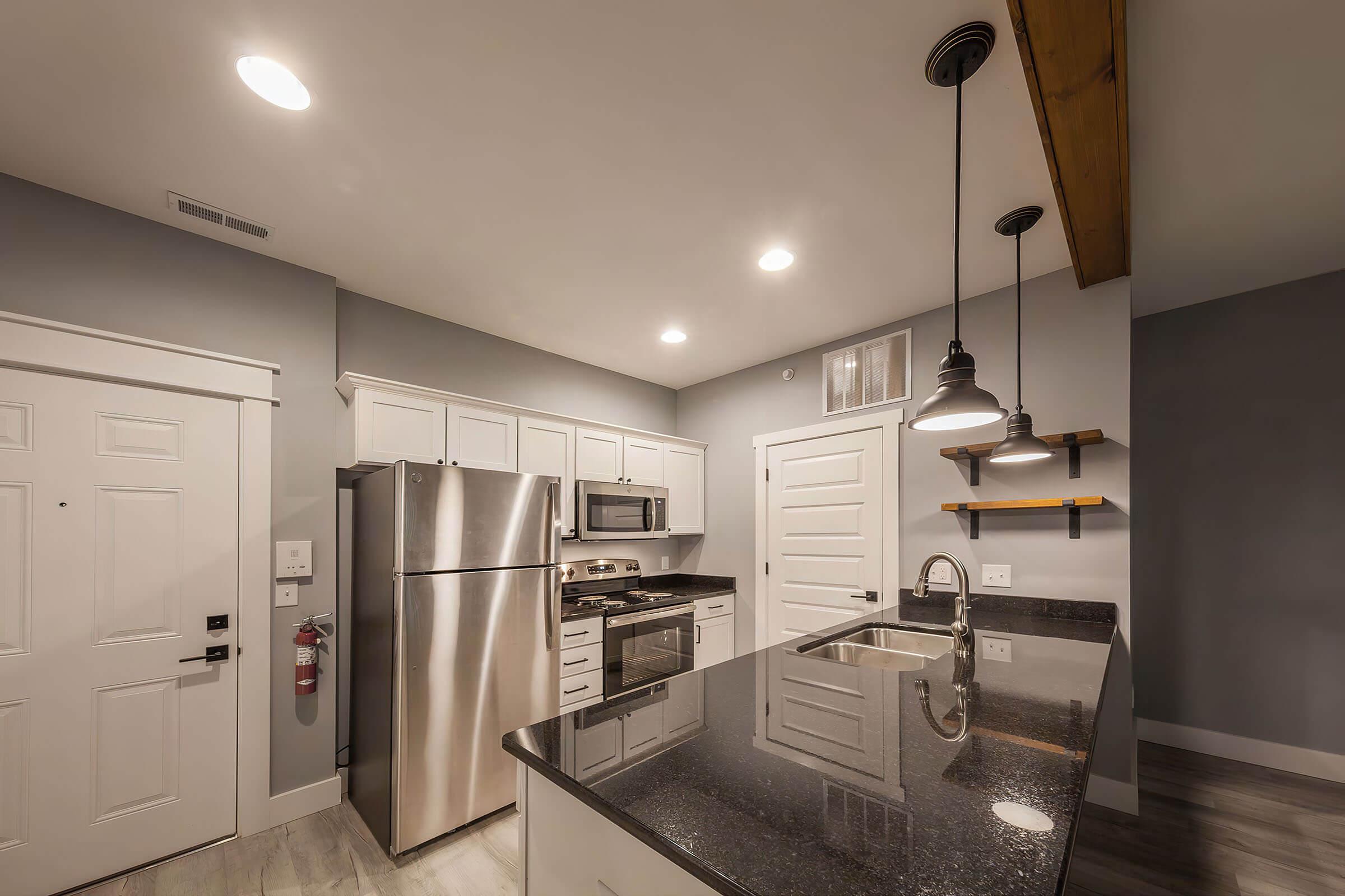 a kitchen with a sink and a refrigerator