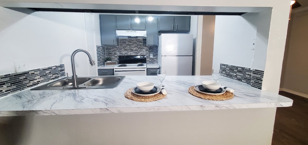 a stove top oven sitting inside of a kitchen