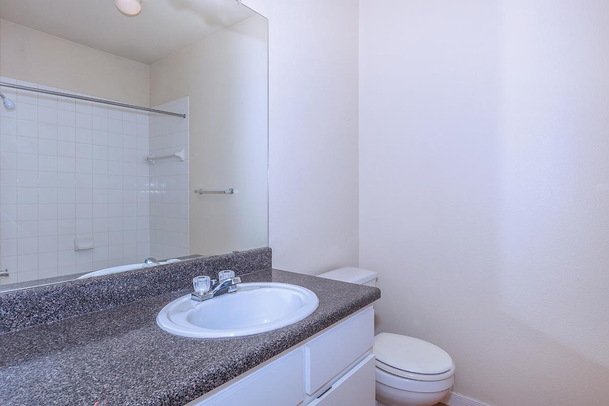 a white sink and a mirror